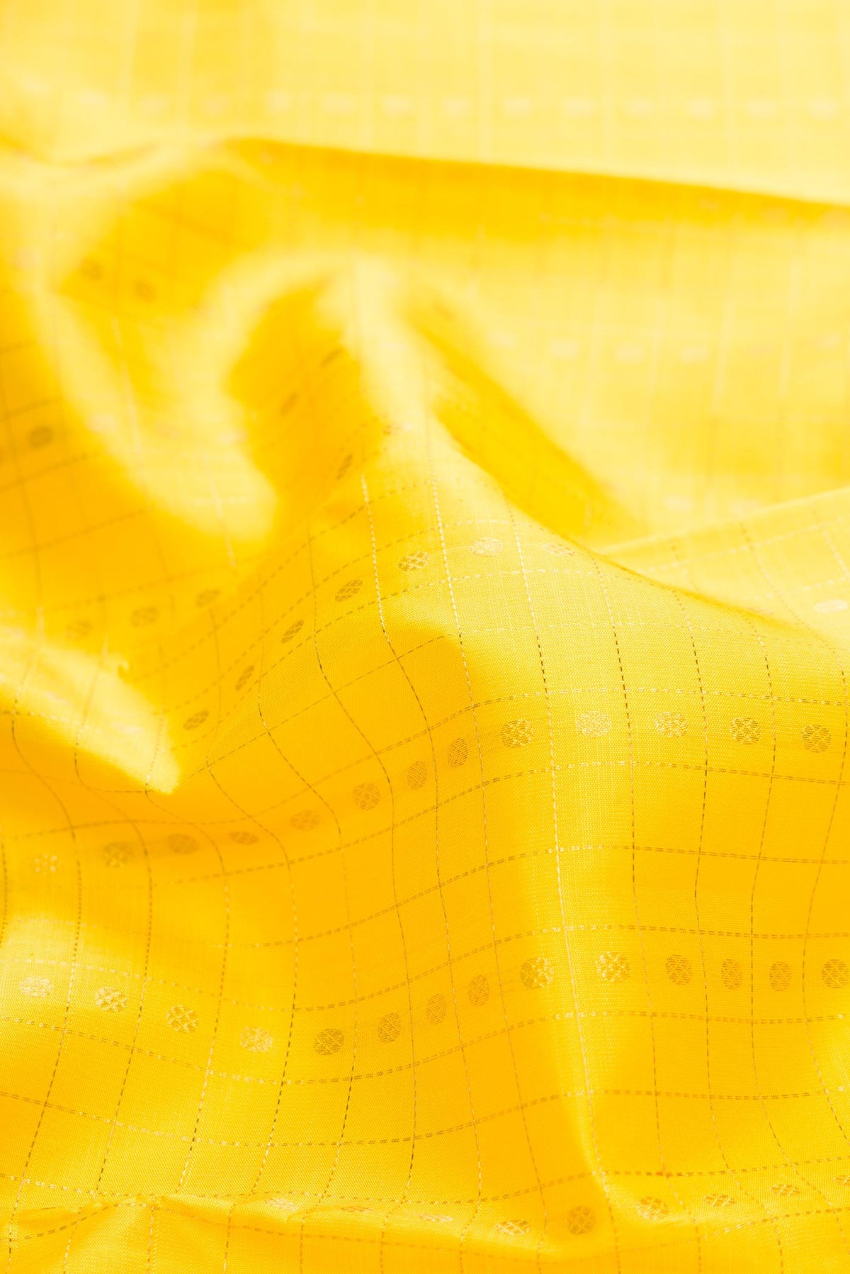 Close up of Pure Silk Pure Zari Yellow Dual Tone Kanchipuram Saree with Zari Butta on the body and Zari Border displaying folds