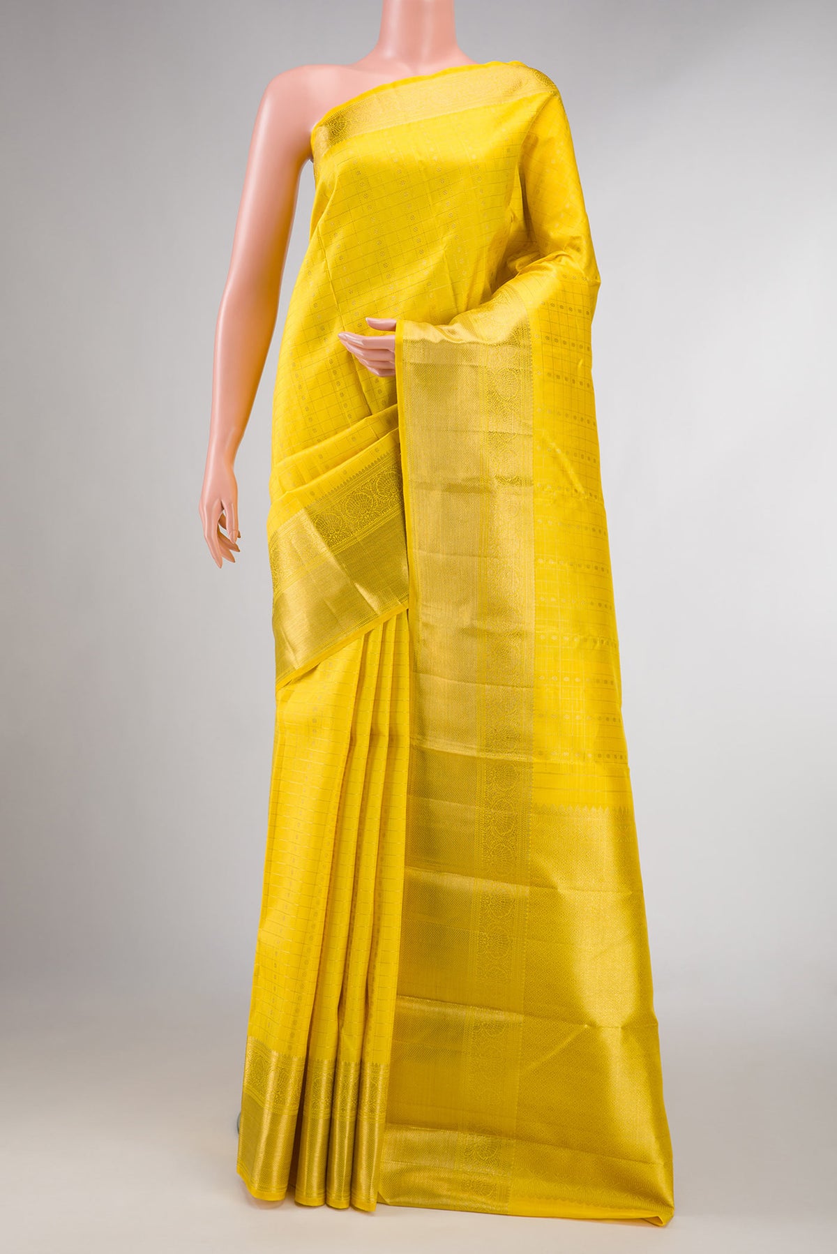 Pure Silk Pure Zari Yellow Dual Tone Kanchipuram Saree with Zari Butta on the body and Zari Border displayed on a mannequin