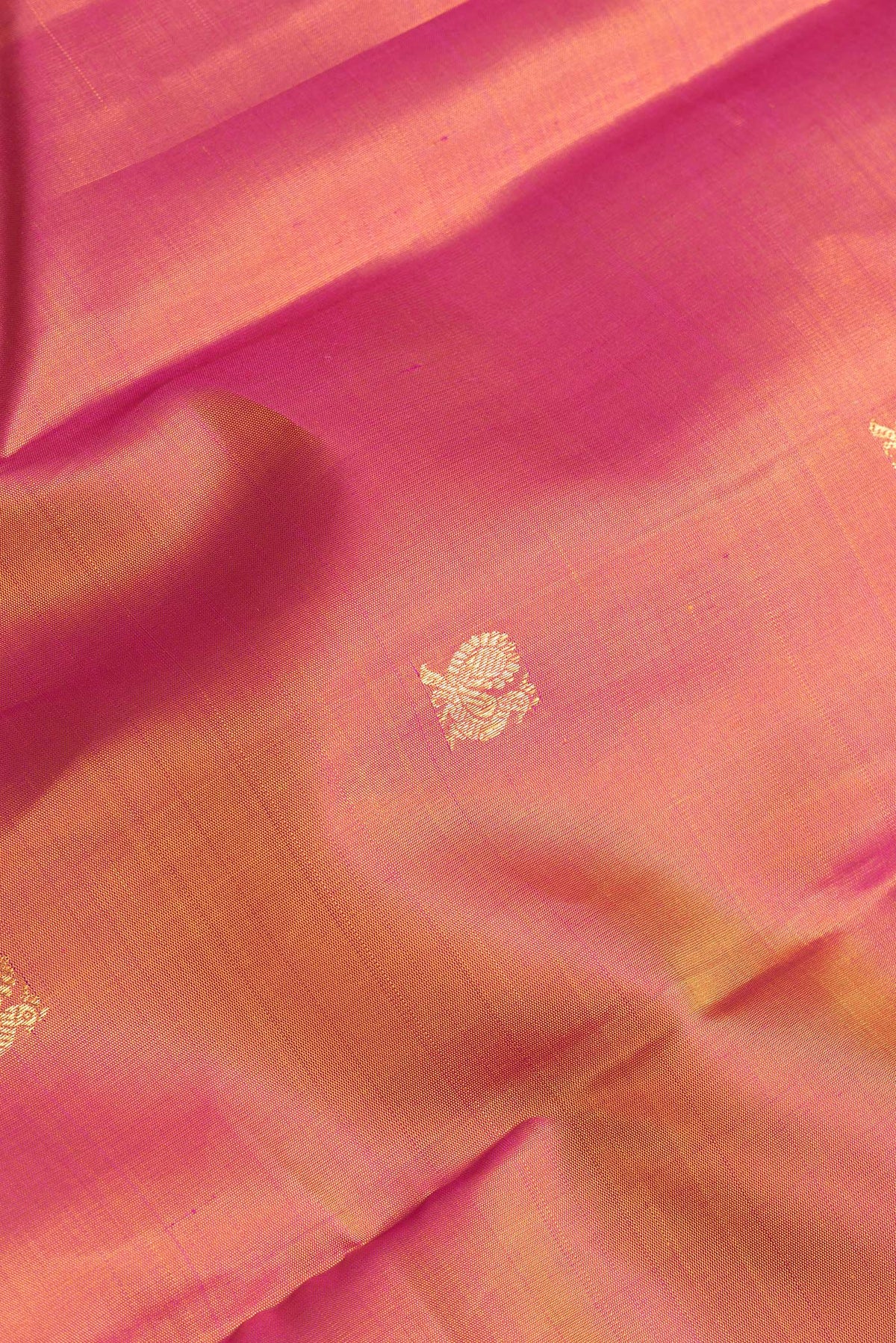 Close up of Mustard Dual Tone Kanchipuram Silk Saree with Zari Butta on the body and Zari Border.  displaying folds