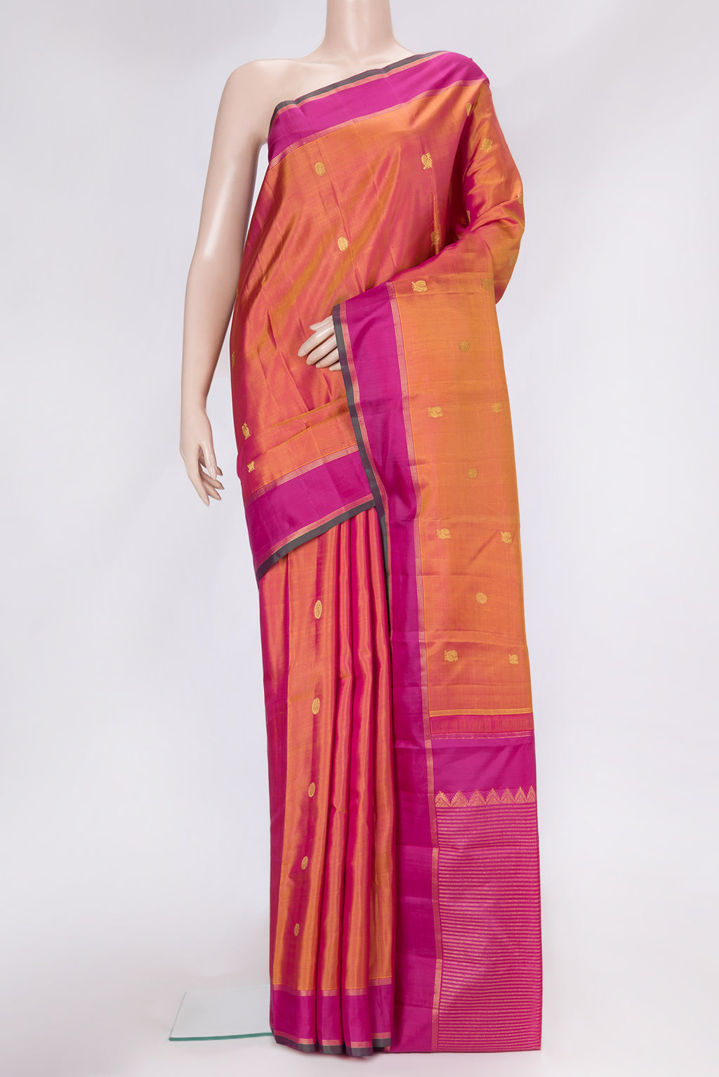 Mustard Dual Tone Kanchipuram Silk Saree with Zari Butta on the body and Zari Border.  displayed on a mannequin