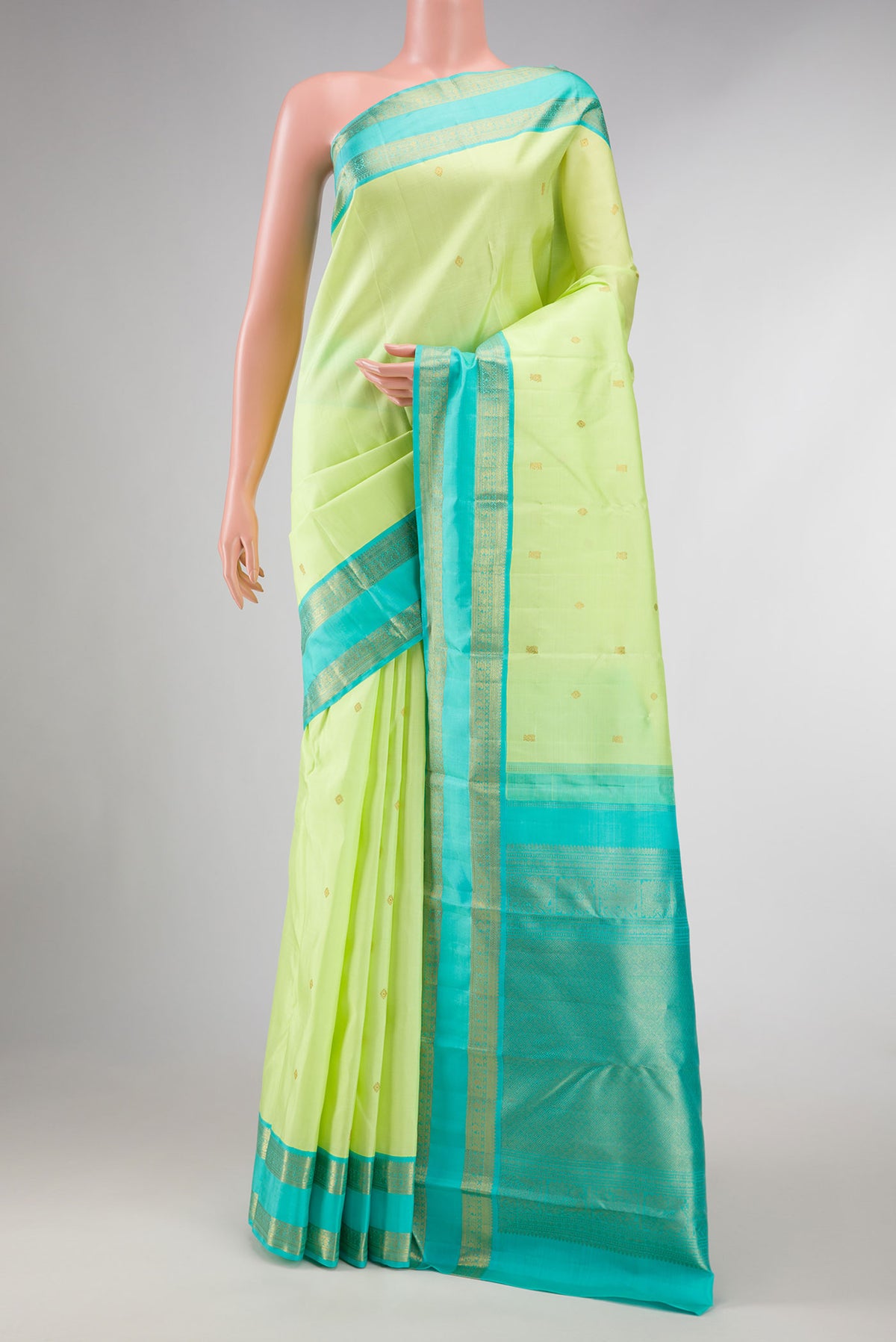 Pure Silk Pure Zari Parrot Green Dual Tone Kanchipuram Saree with Zari Butta on the body and Zari Border displayed on a mannequin