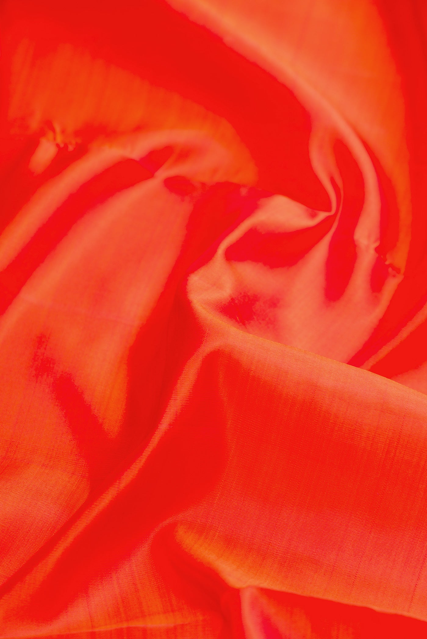 Close up of Pure Silk Pure Zari Orange Dual Tone Kanjivaram Nine Yards Saree with Plain Body and Zari Border.  displaying folds