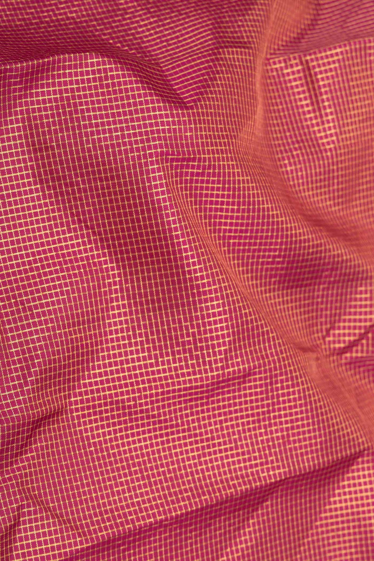 Close up of Red Dual Tone Kanchipuram Saree with Checked design on the body and Zari Border displaying folds