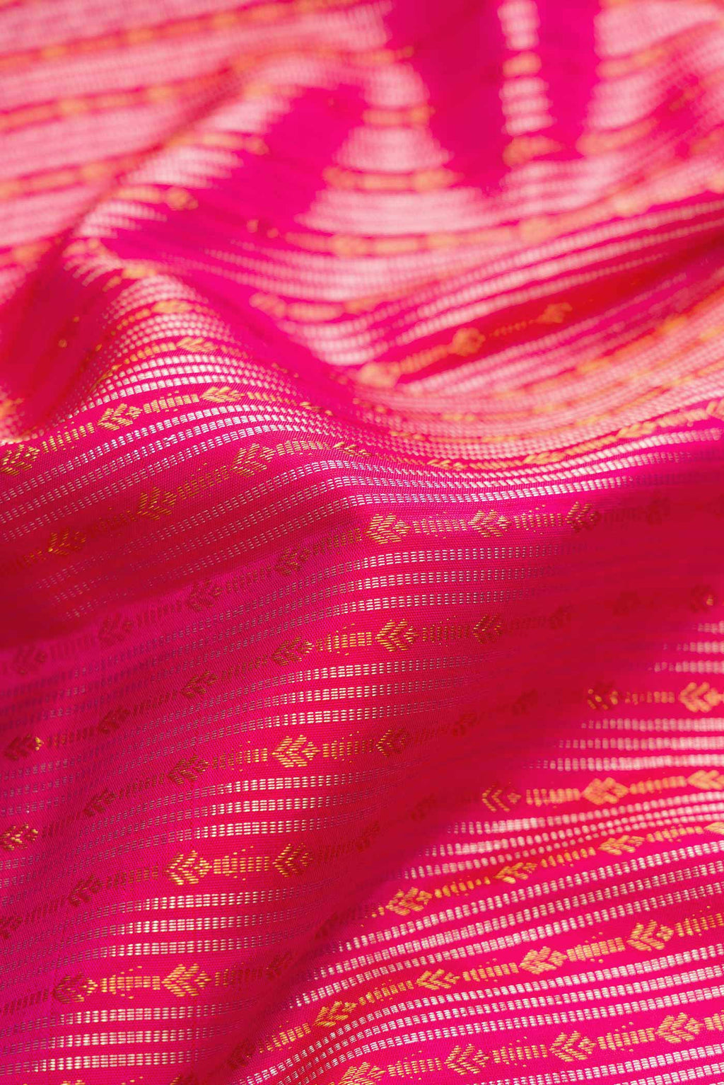 Close up of Pink Dual Tone Kanjivaram Silk Saree with Stripes on the body and Fancy Border.  displaying folds