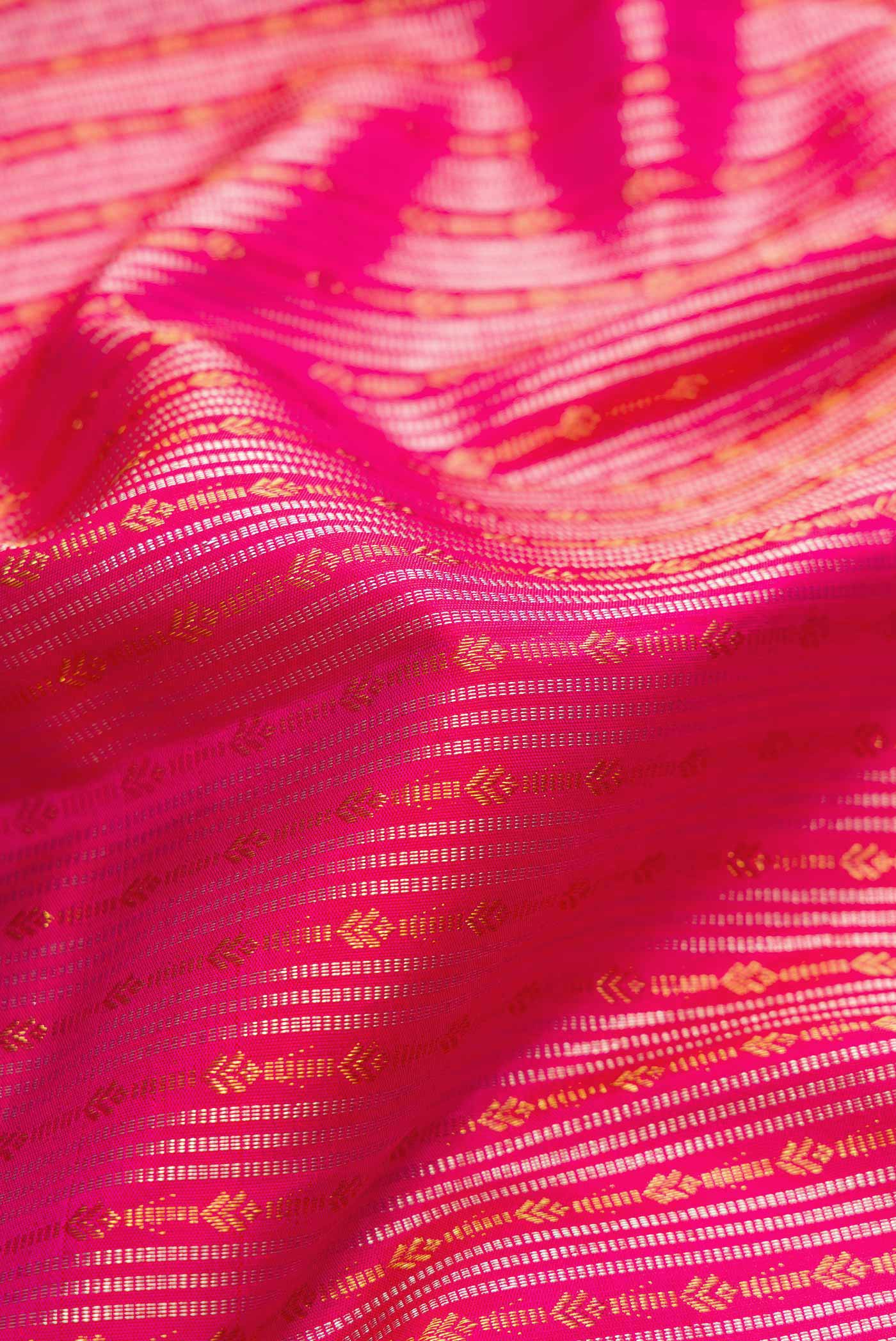 Close up of Pink Dual Tone Kanjivaram Silk Saree with Stripes on the body and Fancy Border.  displaying folds