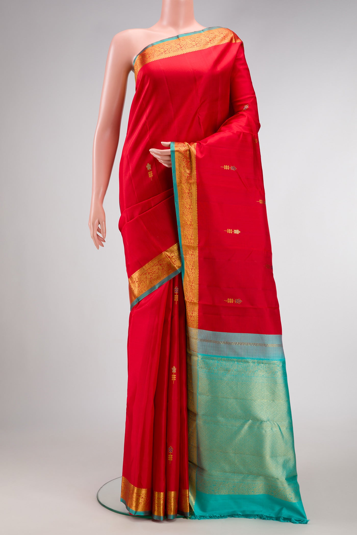 Red Dual Tone Kanchipuram Silk Saree with Zari And Thread Butta on the body and Zari Border.  displayed on a mannequin
