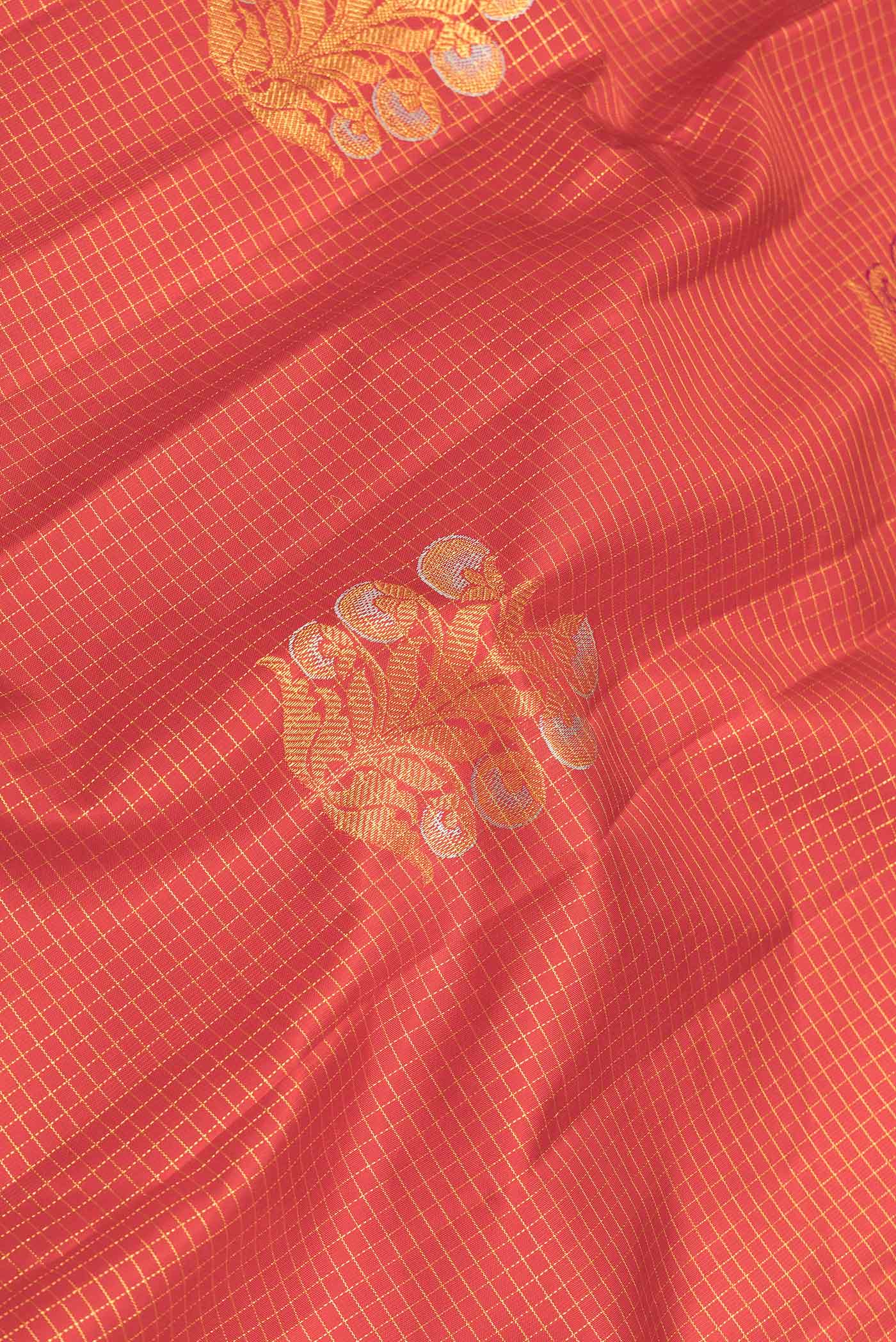Close up of Red Dual Tone Kanchipuram Saree with Checked design on the body and Without Border displaying folds