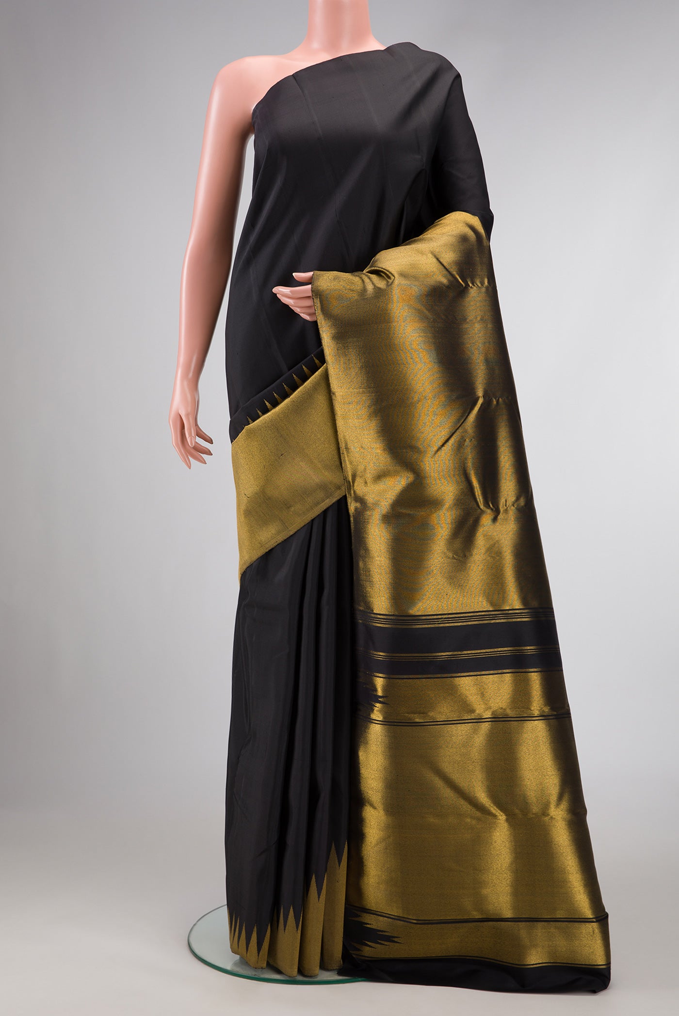 Black Dual Tone Kanchipuram Silk Saree with Plain Body and Rising Temple Border.  displayed on a mannequin