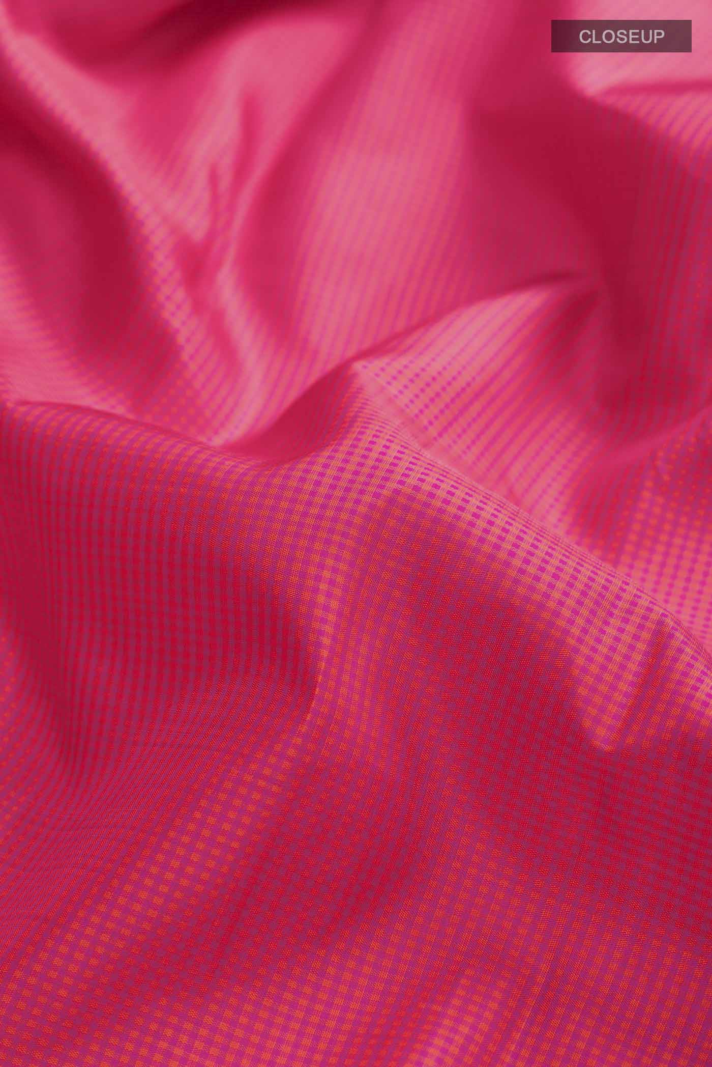 Close up of Pink Kanchipuram Silk Saree with Checked design on the body and Zari Border displaying folds