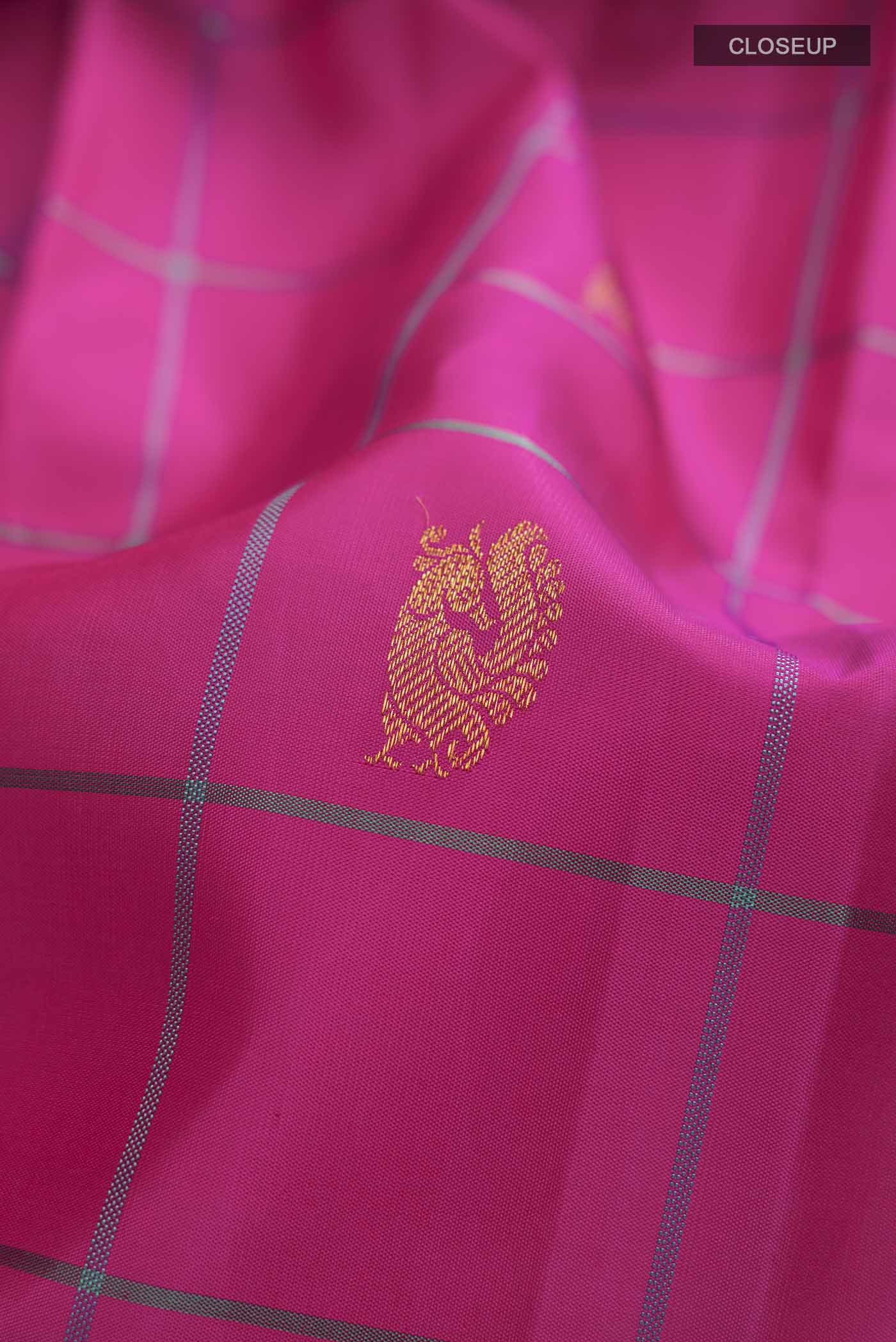 Close up of Pink Kanchipuram Silk Saree with Zari Butta on the body and Plain Border displaying folds