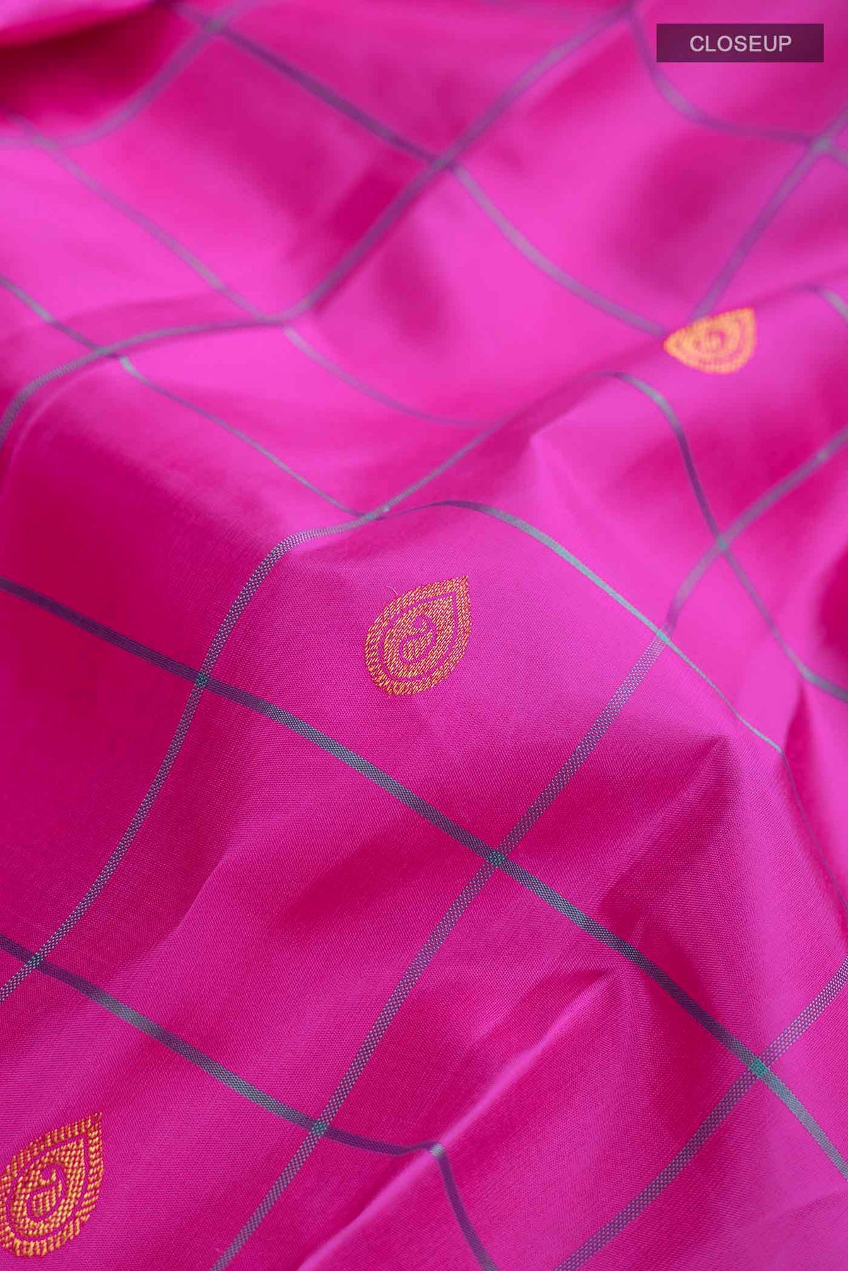 Close up of Pink Kanchipuram Silk Saree with Zari Butta on the body and Plain Border displaying folds