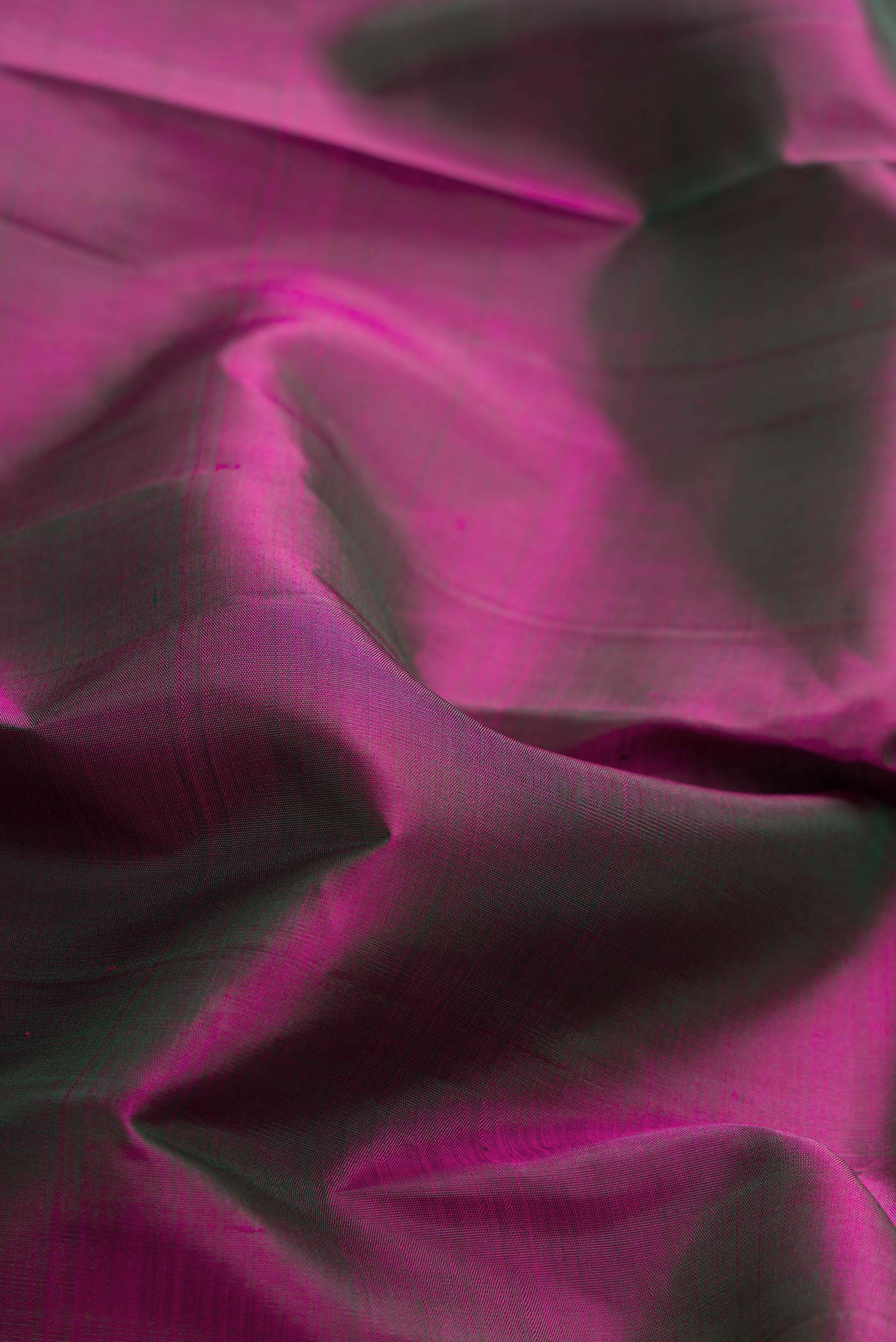 Close up of Purple Dual Tone Kanchipuram Silk Saree with Plain Body and Zari Border displaying folds