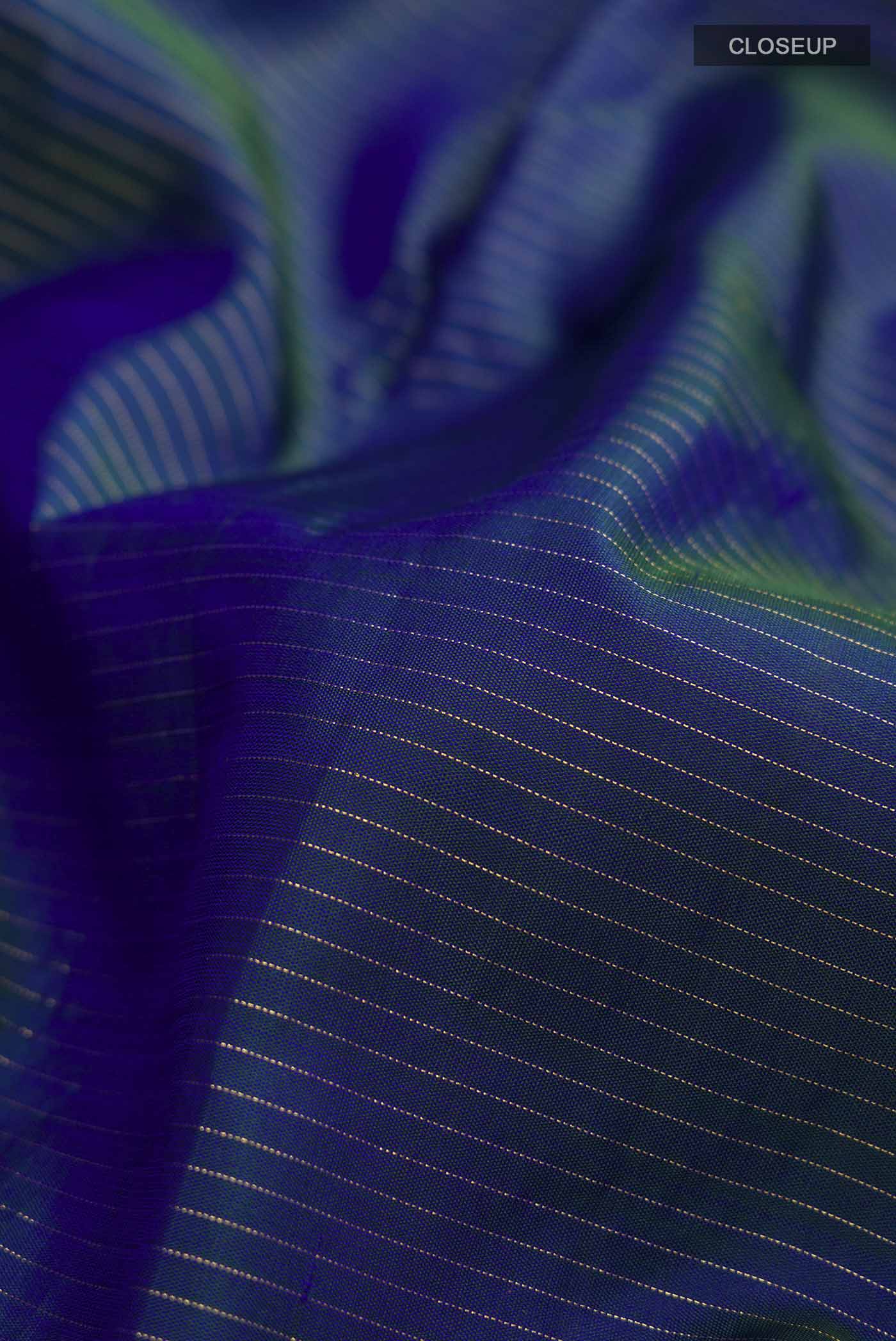 Close up of Blue Kanchipuram Silk Saree with Stripes on the body and Zari Border displaying folds