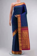 Blue Kanchipuram Silk Saree with Stripes on the body and Zari Border displayed on a mannequin