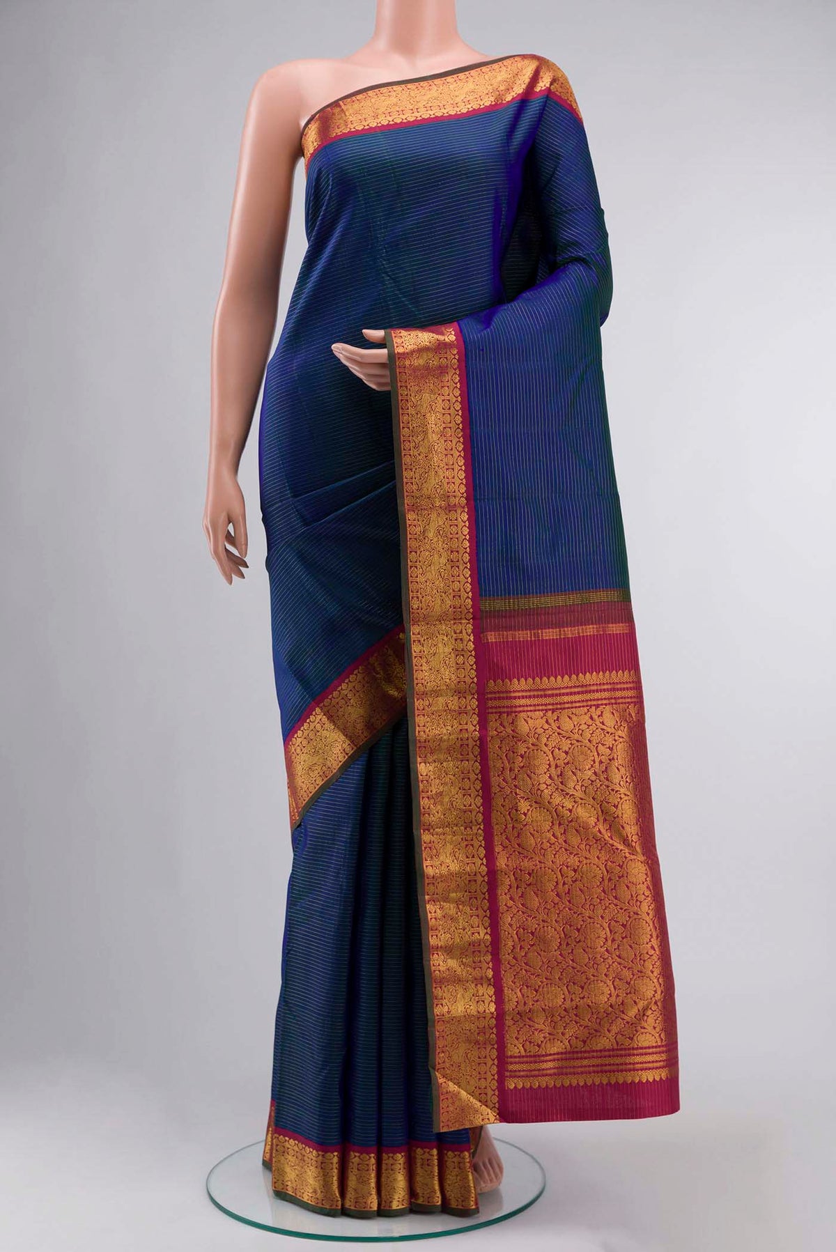 Blue Kanchipuram Silk Saree with Stripes on the body and Zari Border displayed on a mannequin