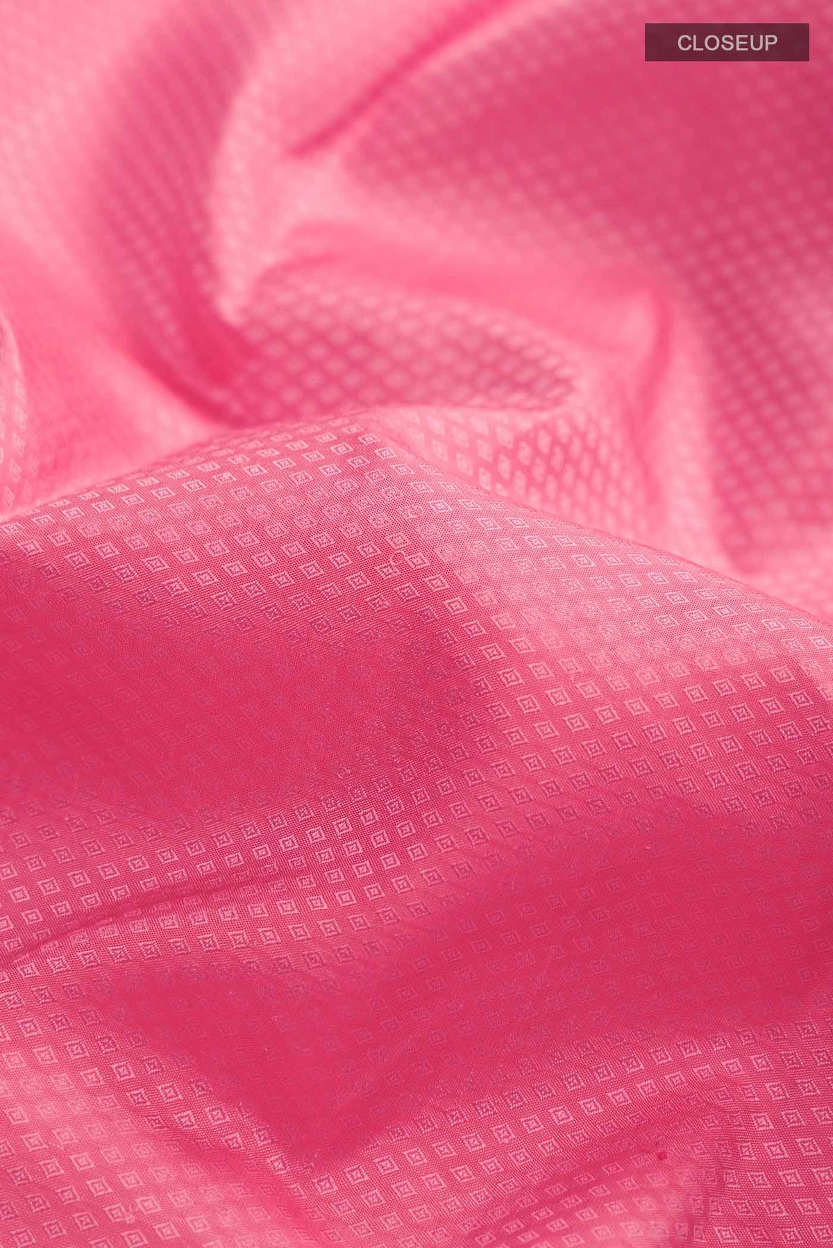 Close up of Rose pink Kanchipuram Silk SareeJacquard design on the body and Zari Border displaying folds