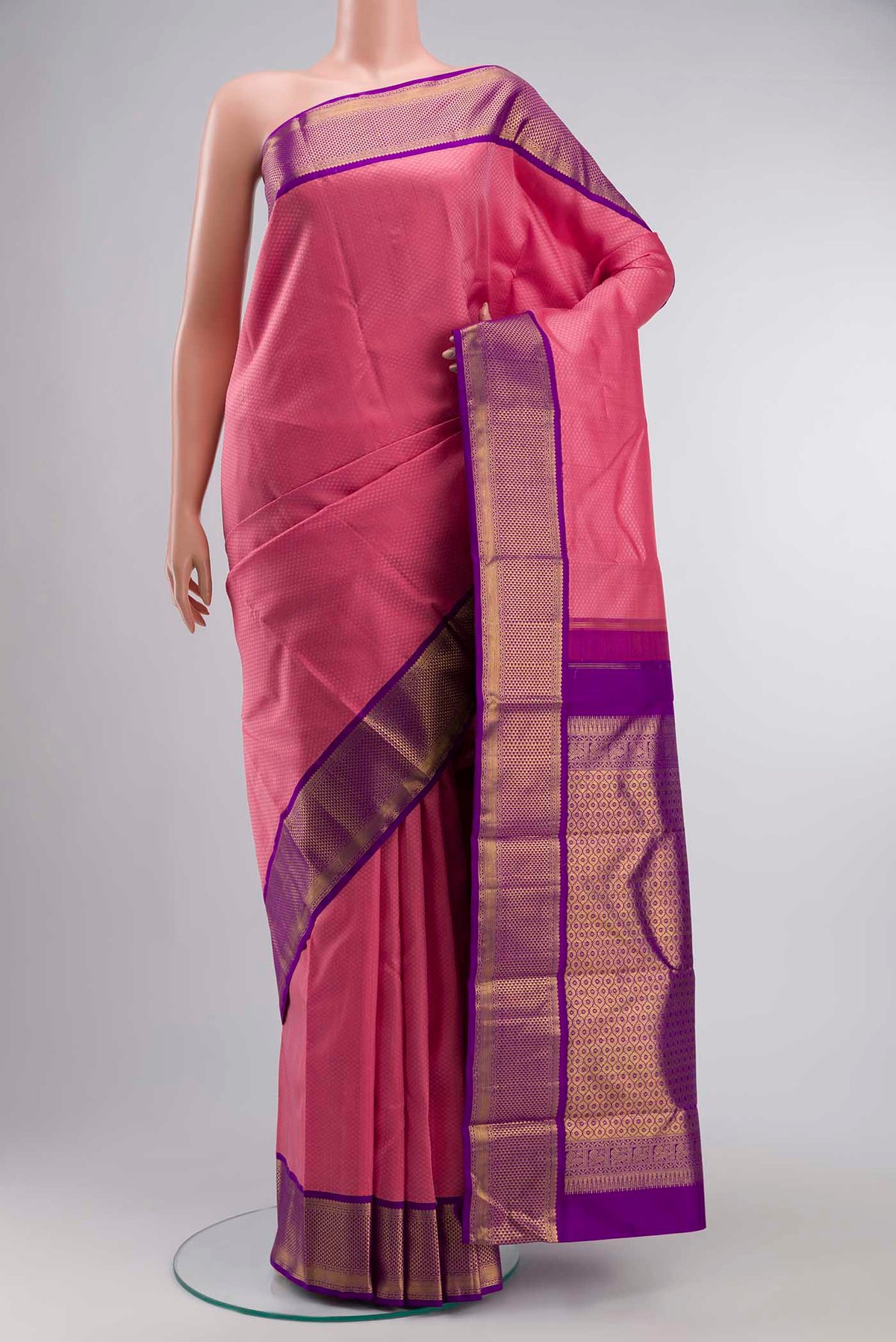 Rose pink Kanchipuram Silk SareeJacquard design on the body and Zari Border displayed on a mannequin
