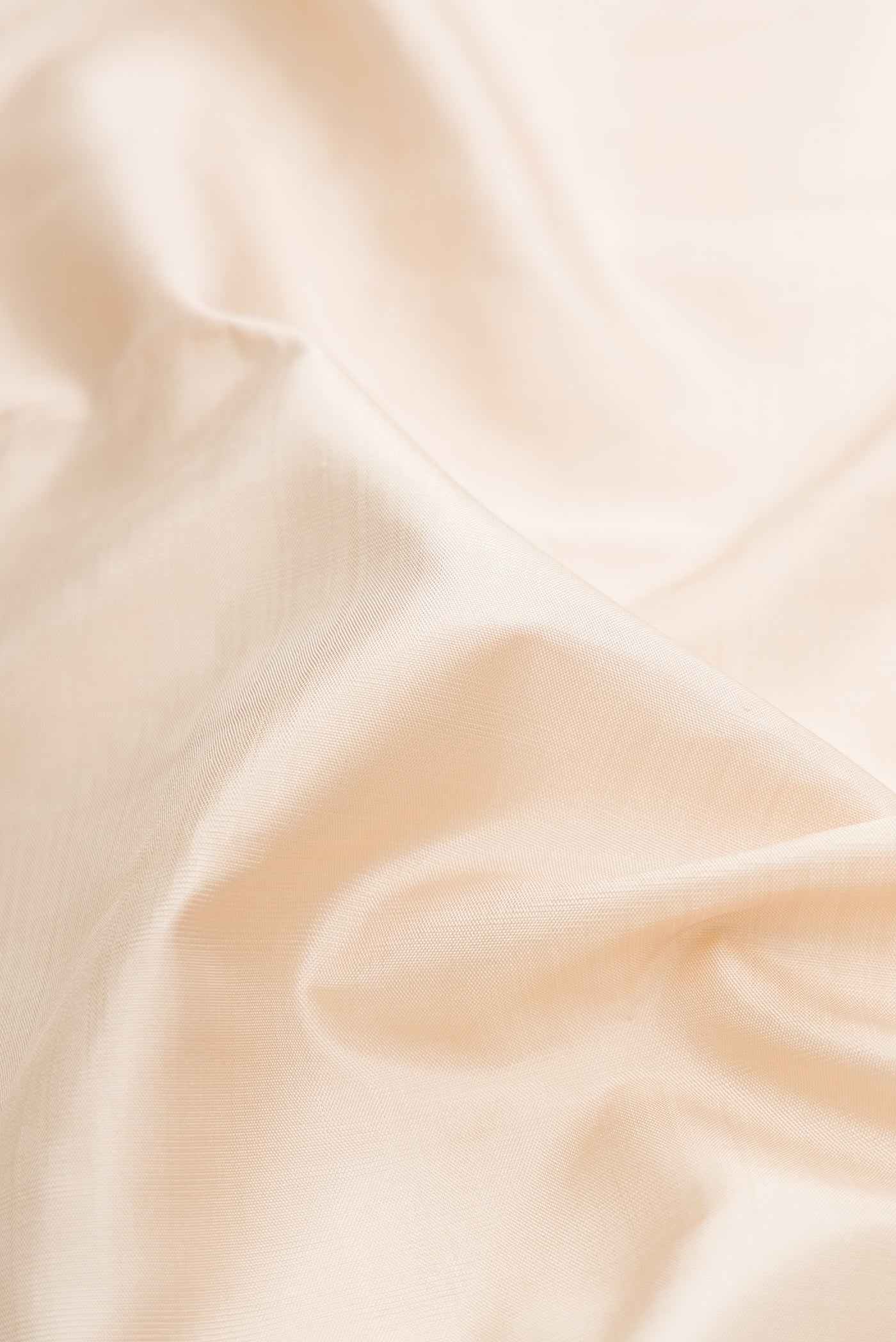 Close up of Pure Silk Pure Zari Off White Dual Tone Kanchipuram Saree with Plain Body and Zari Border displaying folds