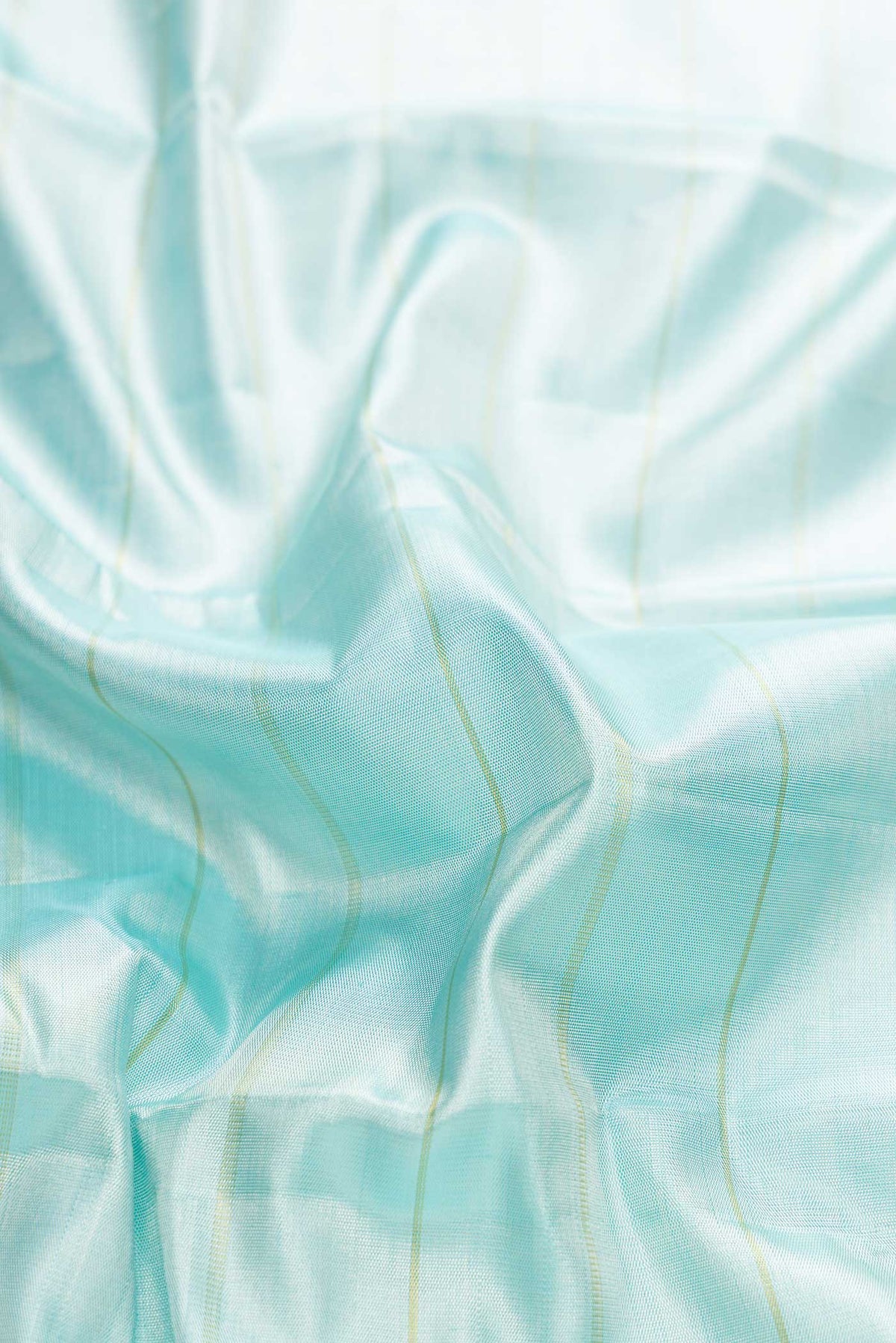 Close up of Sky Blue Dual Tone Kanchipuram Tissue Silk Saree with Stripes on the body and Zari Border displaying folds