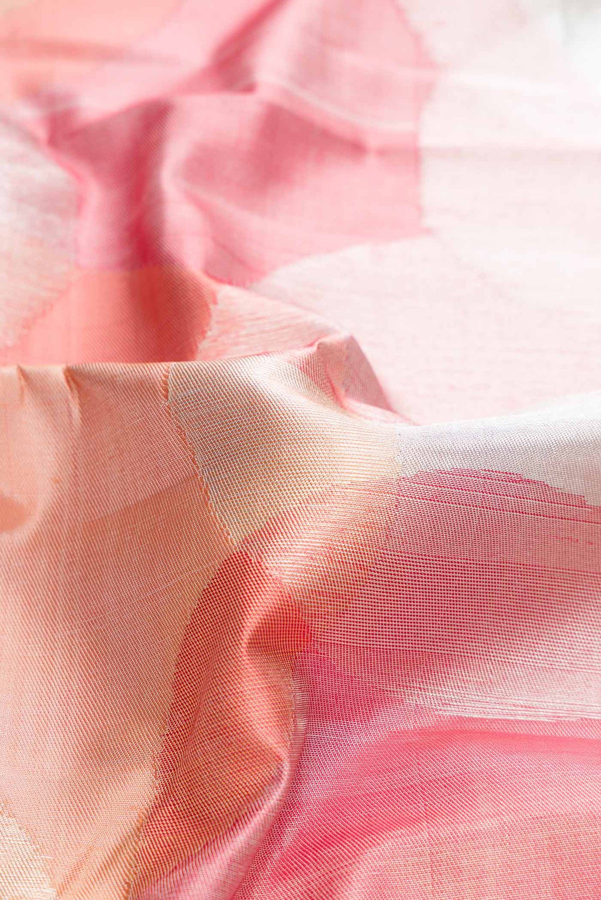 Close up of Pink , Maroon and Orange Dual Tone Kanchipuram Silk Saree with Zari Brocade on the body and Zari Border displaying folds