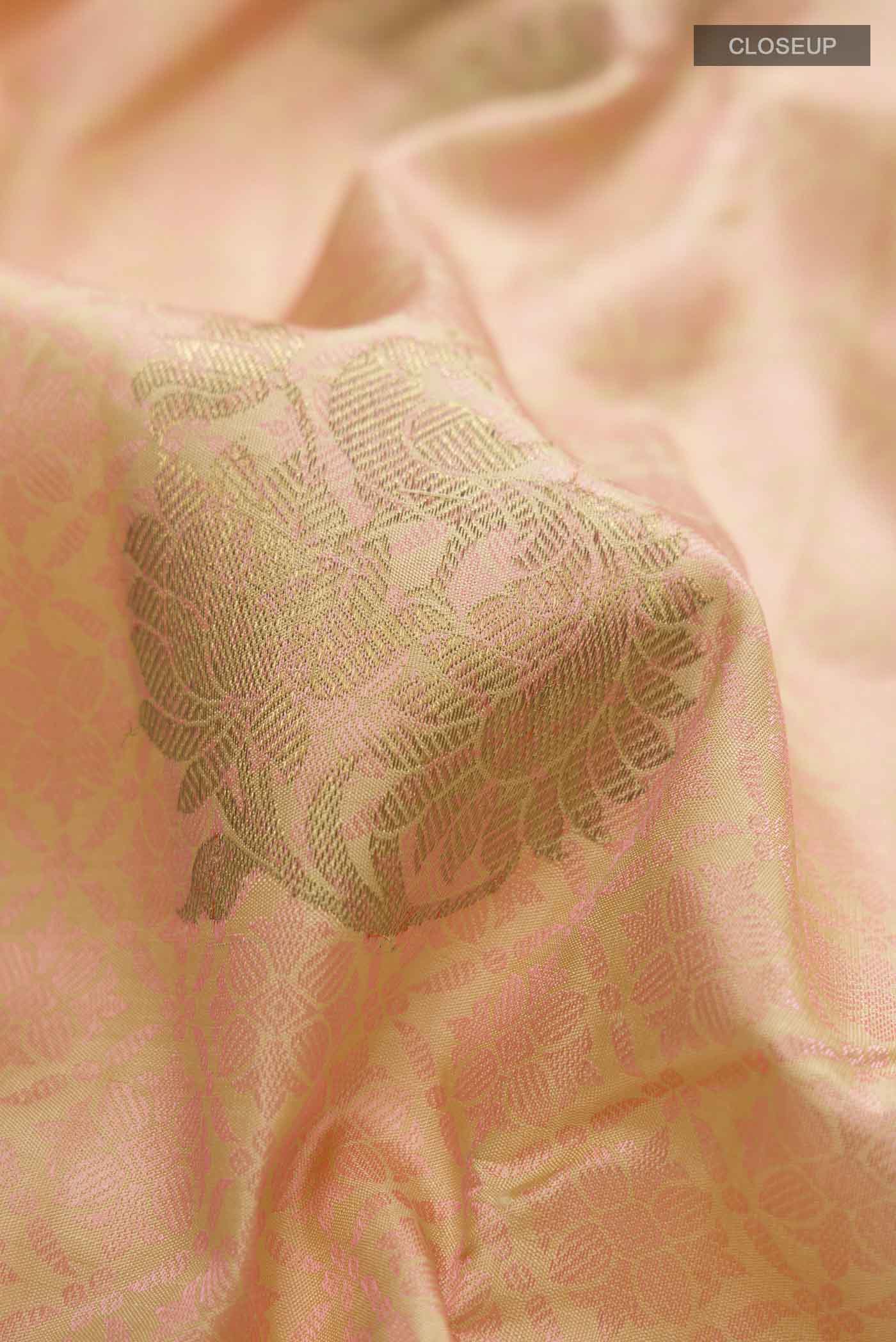 Close up of Pink Kanchipuram Silk Saree with Jacquard With Zari Butta on the body and Zari Border displaying folds