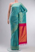 Green Kanchipuram Silk Saree with Jacquard With Zari Butta on the body and Without Border displayed on a mannequin