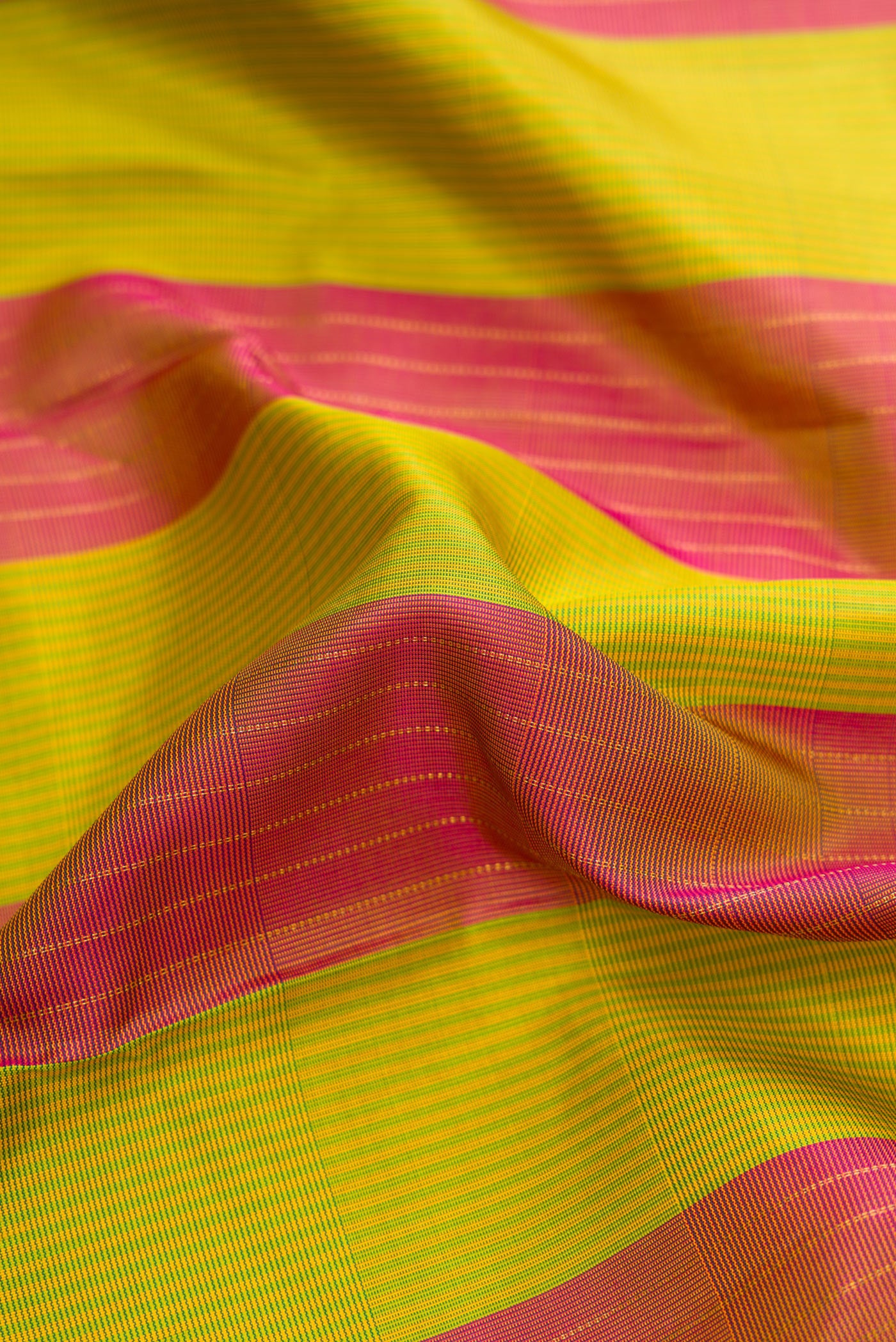 Close up of Parrot Green Dual Tone Kanjivaram Silk Saree with Stripes on the body and Without Border.  displaying folds