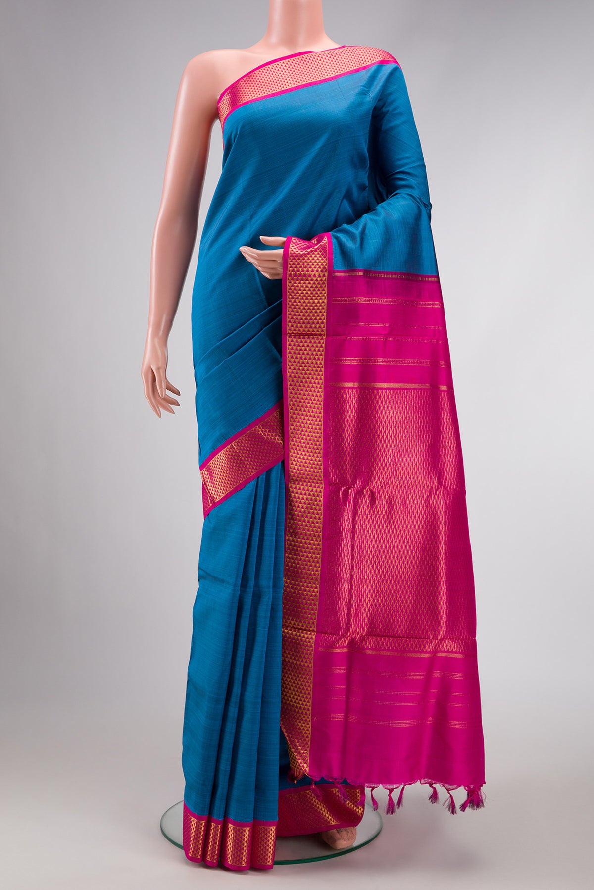 Pure Silk Pure Zari Peacock Blue Dual Tone Kanjivaram Nine Yards Saree with Plain Body and Zari Border.  displayed on a mannequin