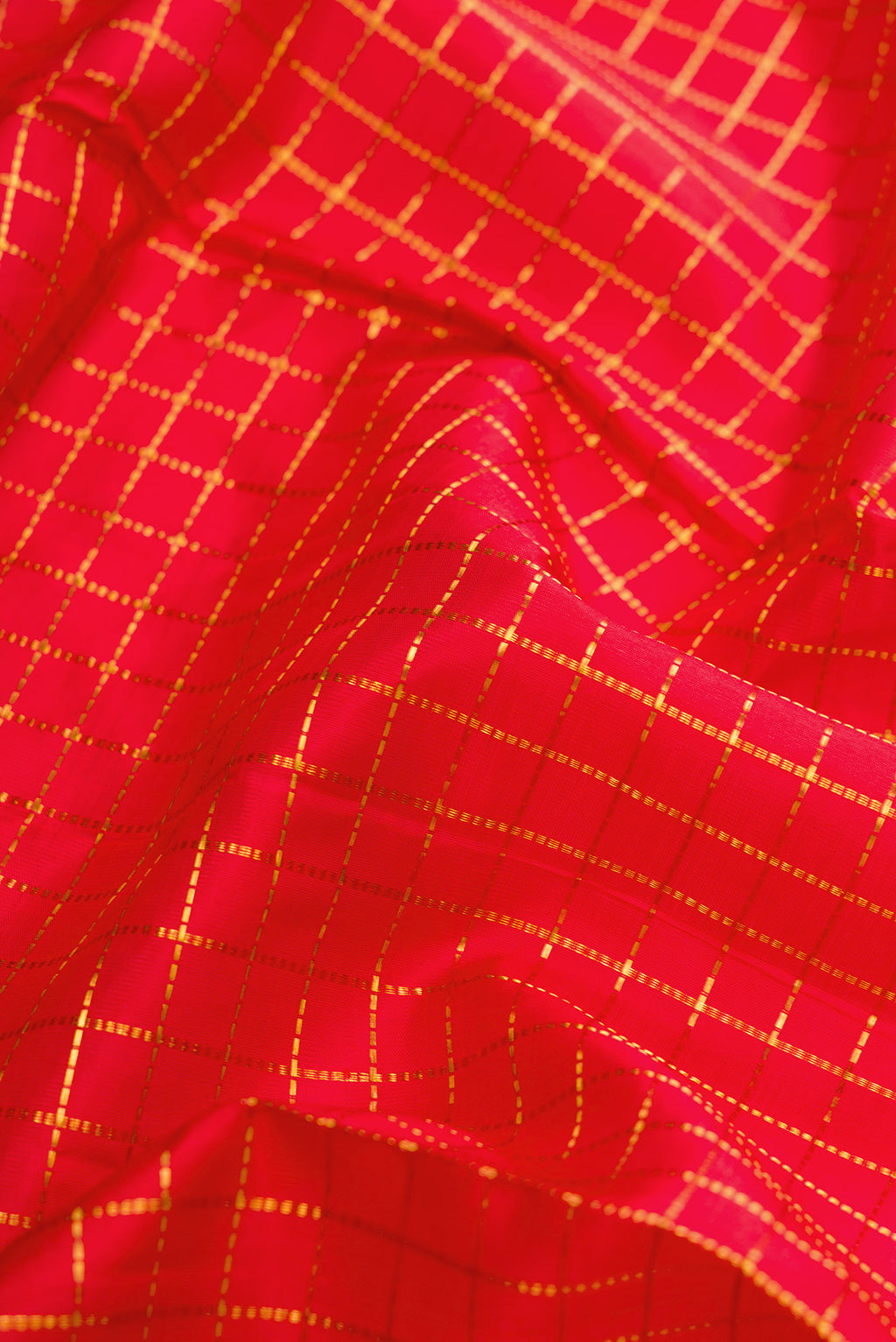 Close up of Pure Silk Pure Zari Red Dual Tone Kanjivaram Nine Yards Saree with Checked design on the body and Zari Border.  displaying folds