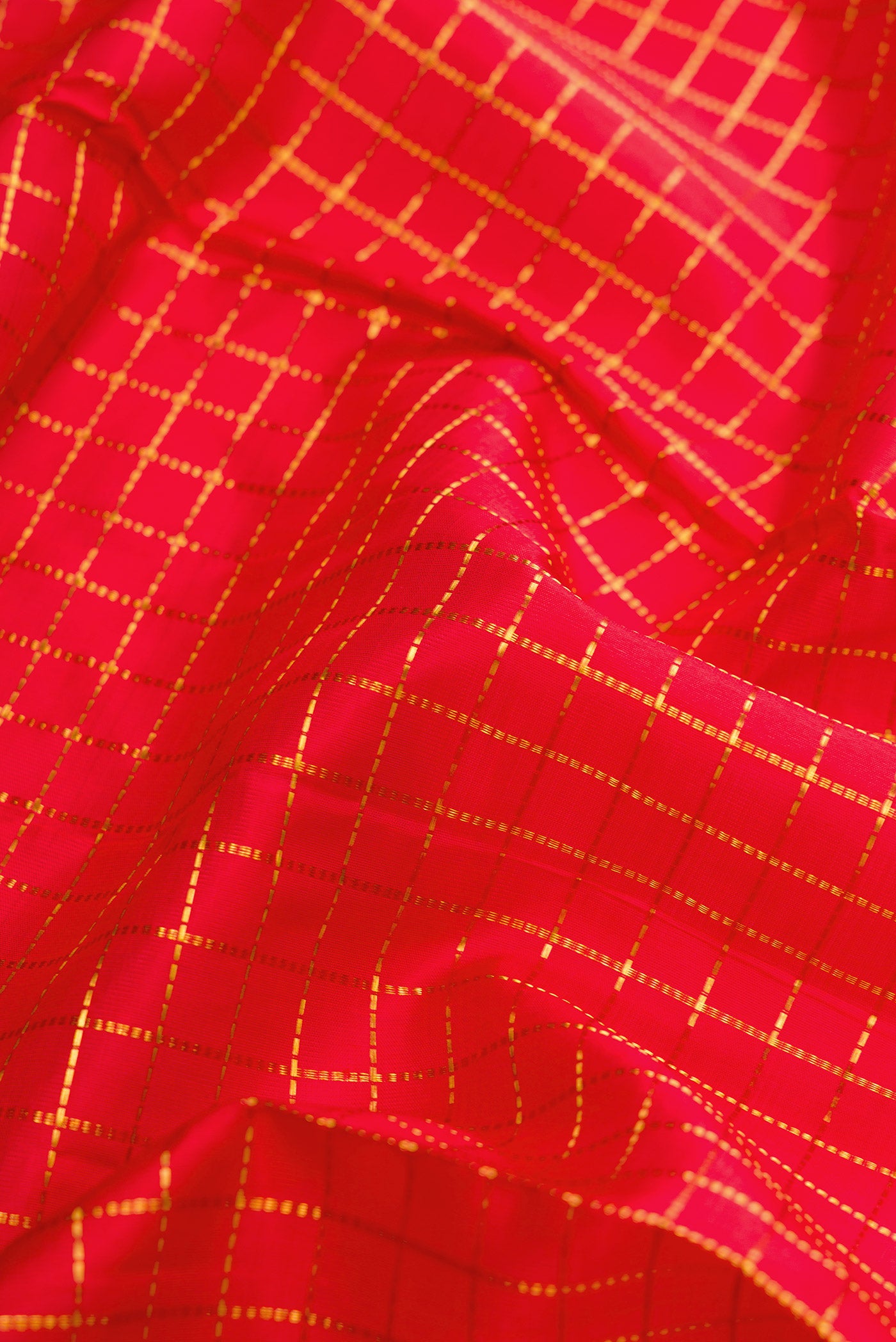 Close up of Pure Silk Pure Zari Red Dual Tone Kanjivaram Nine Yards Saree with Checked design on the body and Zari Border.  displaying folds
