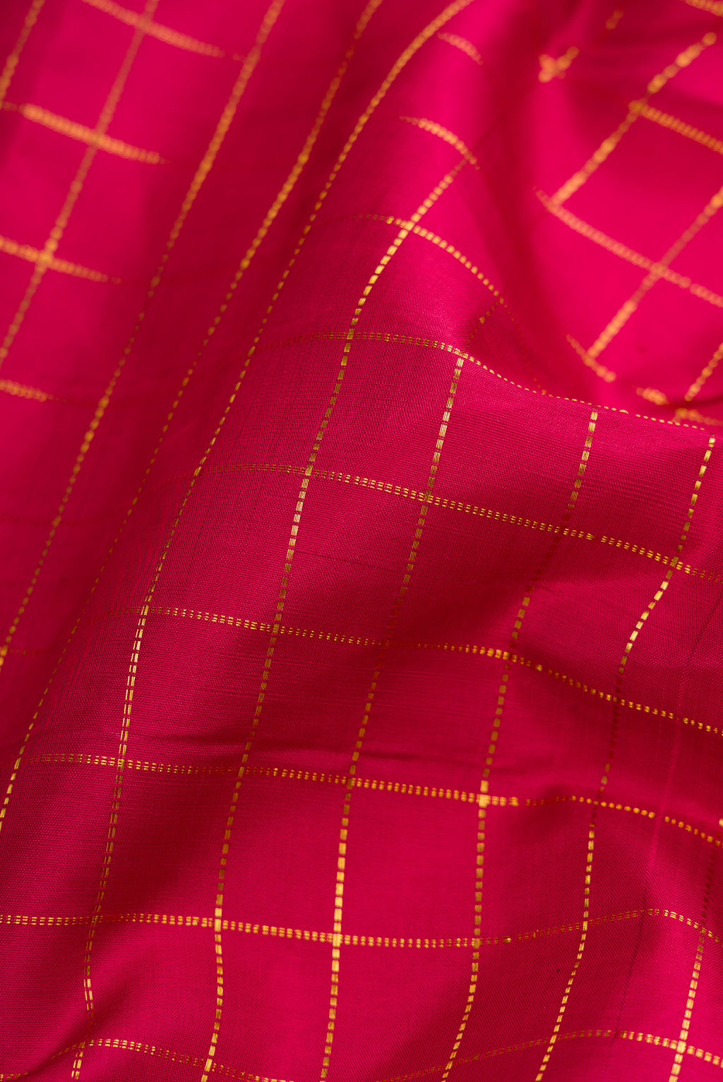 Close up of Red Dual Tone Kanjivaram Silk Nine Yards Saree with Checked design on the body and Zari Border.  displaying folds