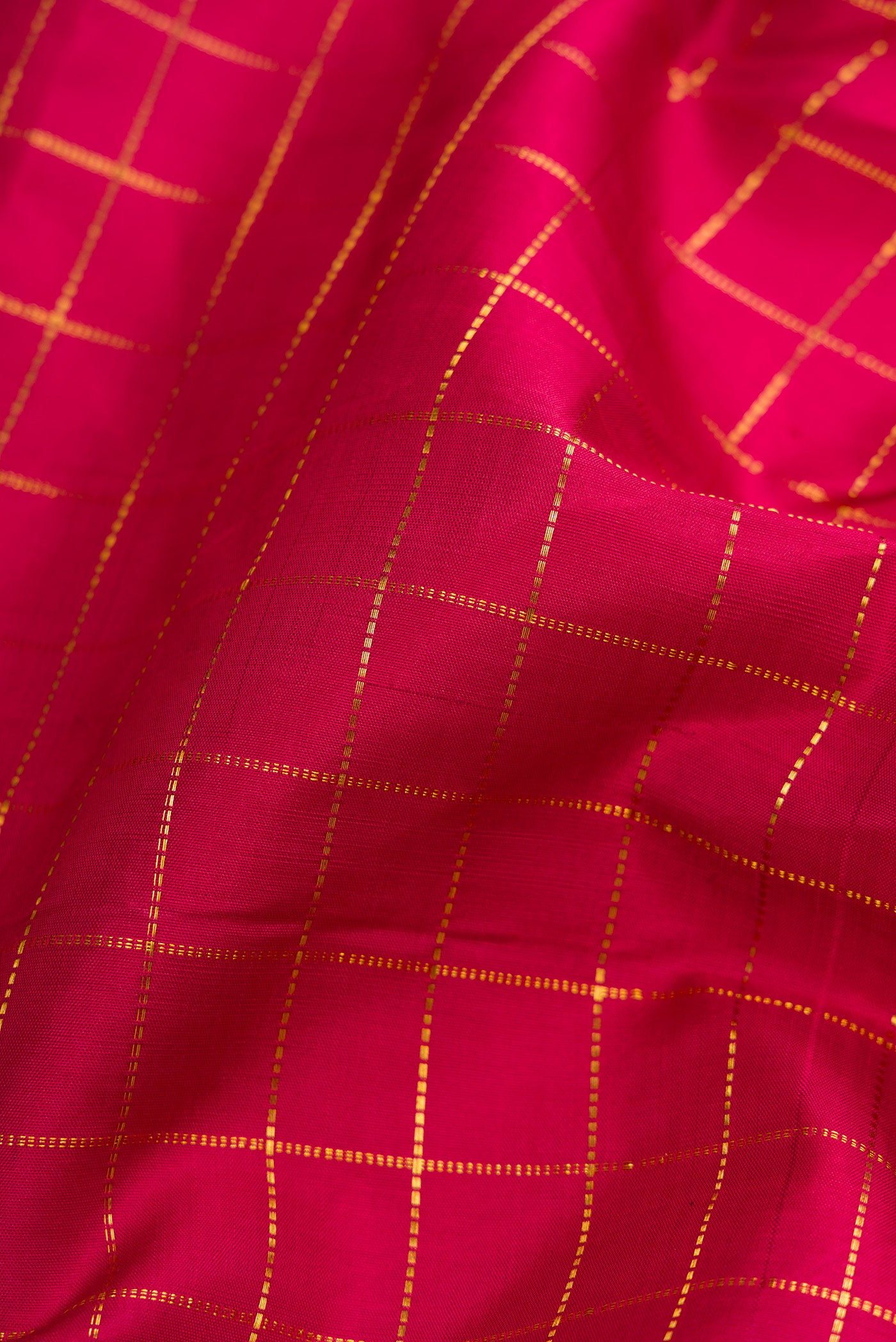 Close up of Red Dual Tone Kanjivaram Silk Nine Yards Saree with Checked design on the body and Zari Border.  displaying folds