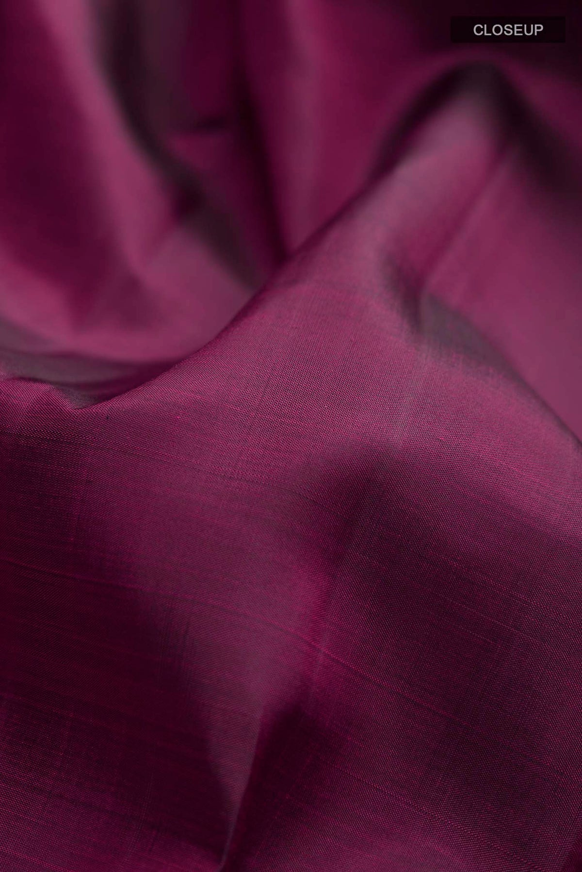 Close up of Maroon Kanchipuram Silk Saree with Plain Body and Zari Border displaying folds