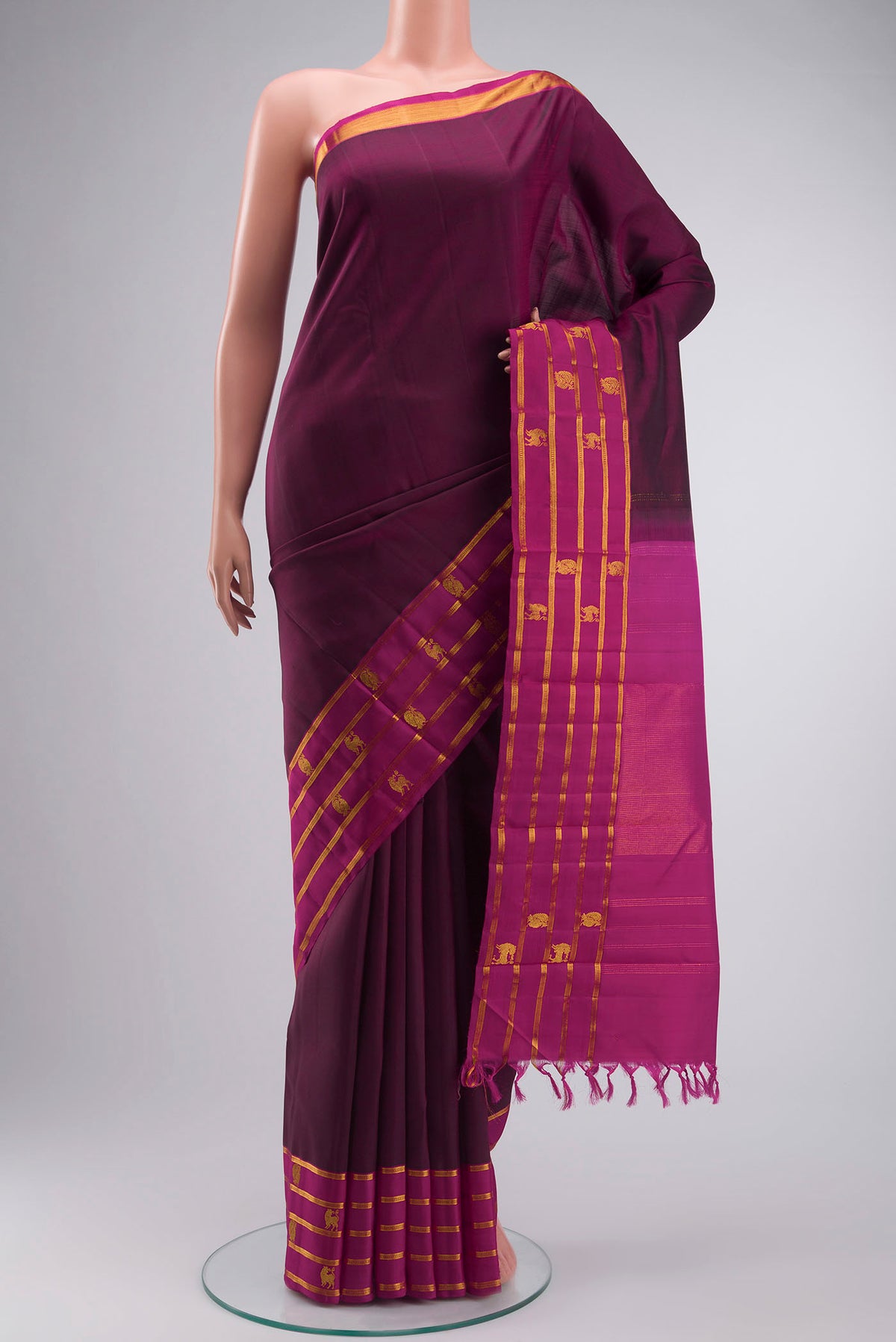 Maroon Kanchipuram Silk Saree with Plain Body and Zari Border displayed on a mannequin