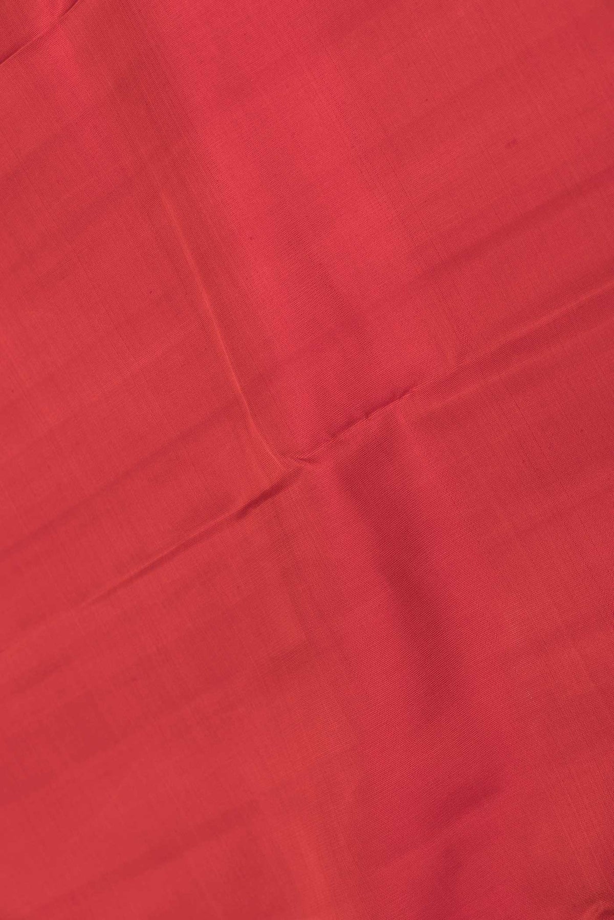 Close up of Red Dual Tone Kanchipuram Saree with Plain Body and Zari Border displaying folds