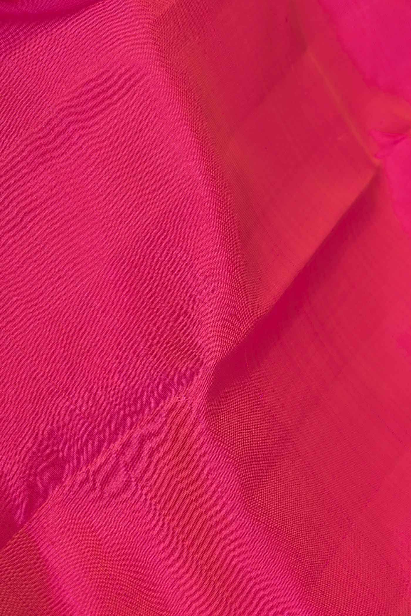 Close up of Pink Dual Tone Kanchipuram Saree with Plain Body and Zari Border displaying folds