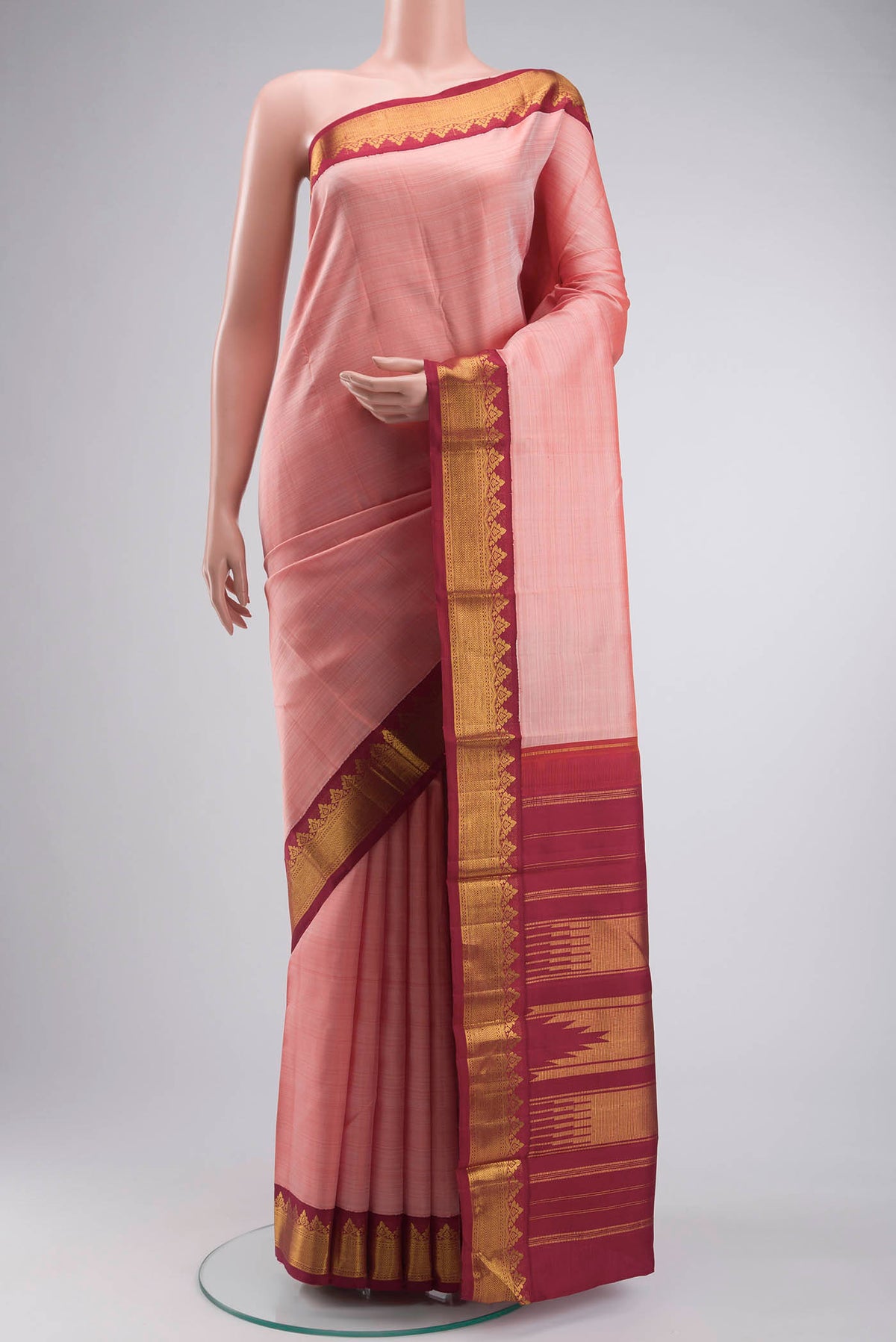 Peach Kanchipuram Silk Saree with Plain Body and Zari Border displayed on a mannequin