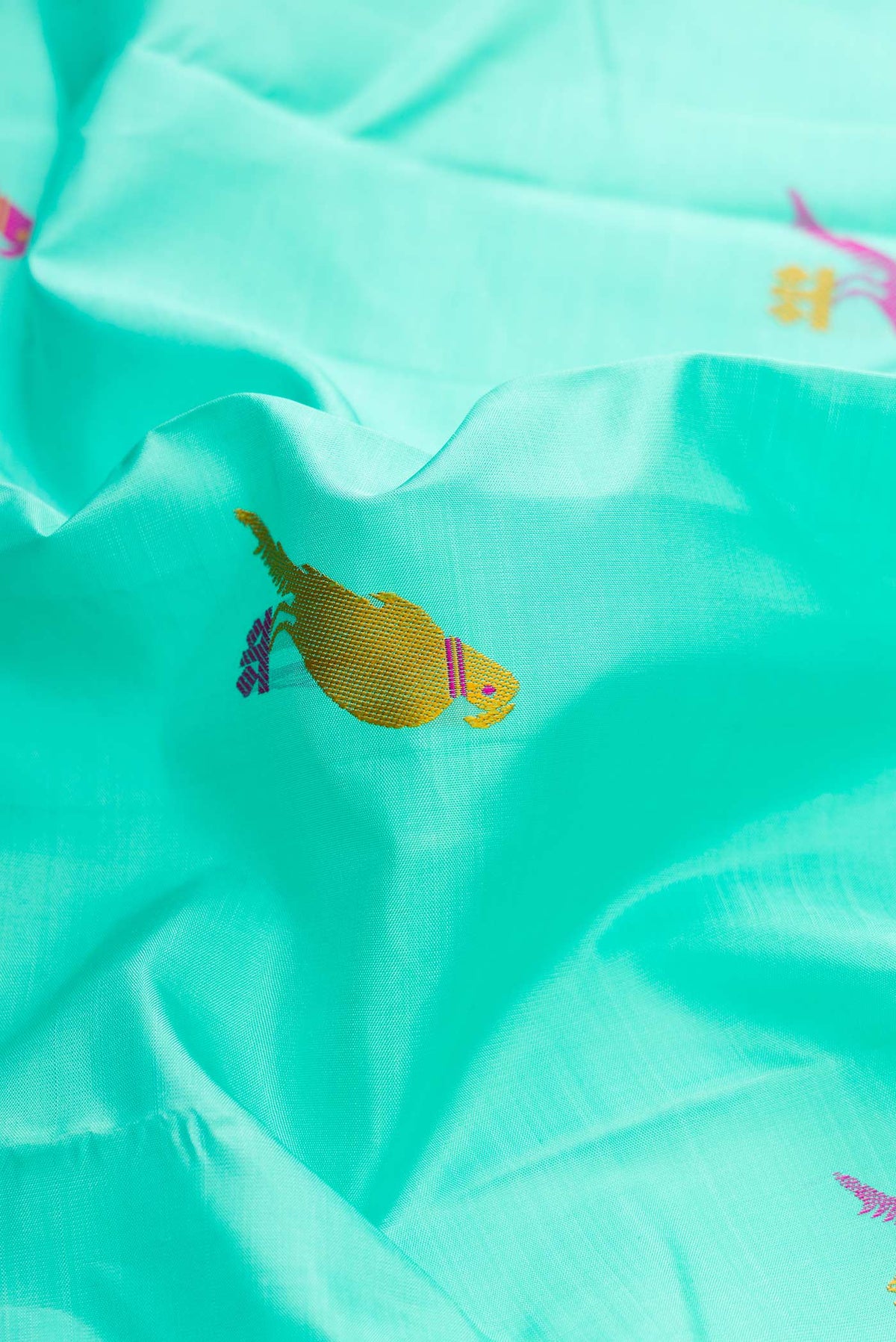 Close up of Sky Blue Dual Tone Kanchipuram Silk Saree with Thread Butta on the body and Thread Border displaying folds