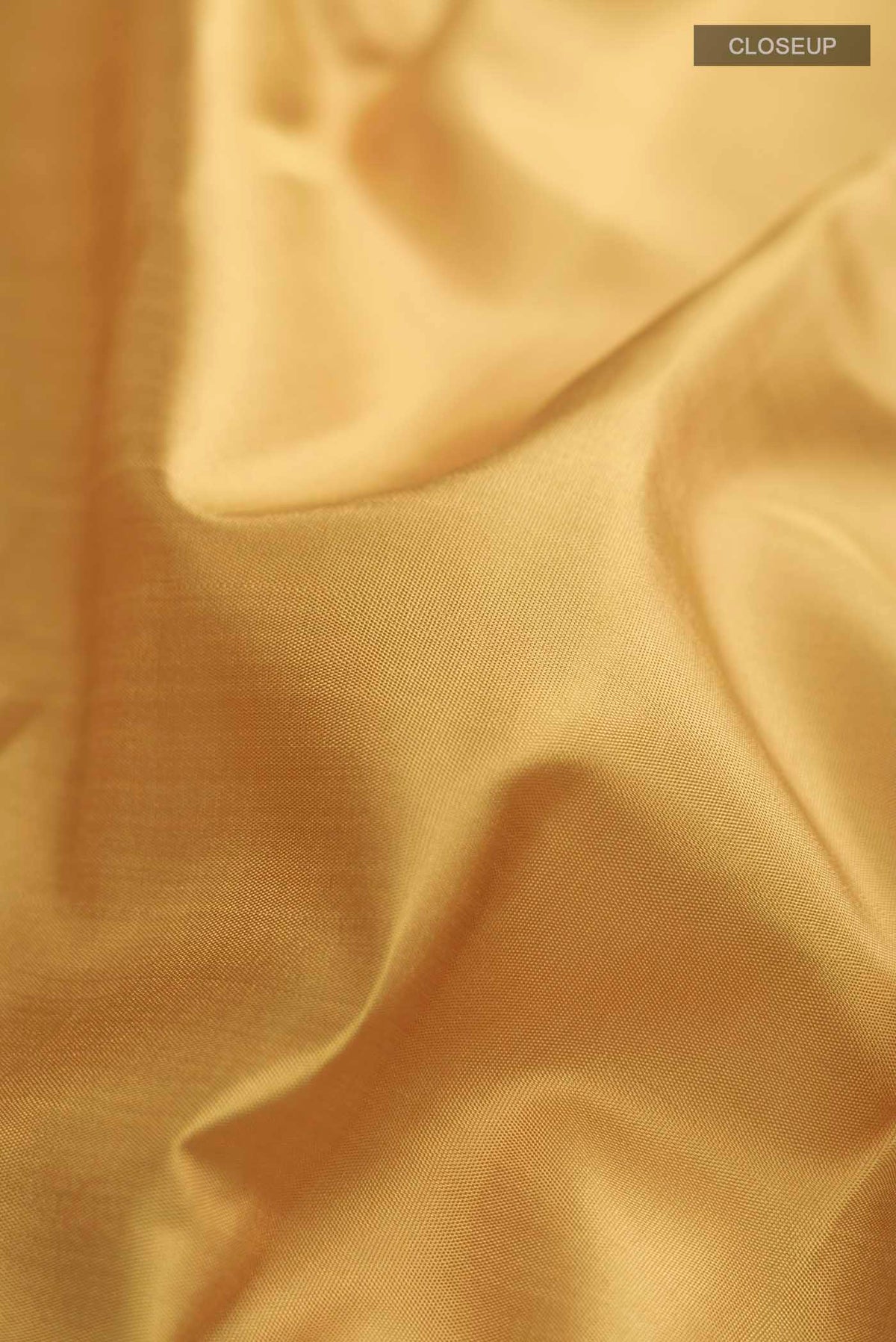 Close up of Mustard Kanchipuram Silk Saree with Plain Body and Zari Border displaying folds