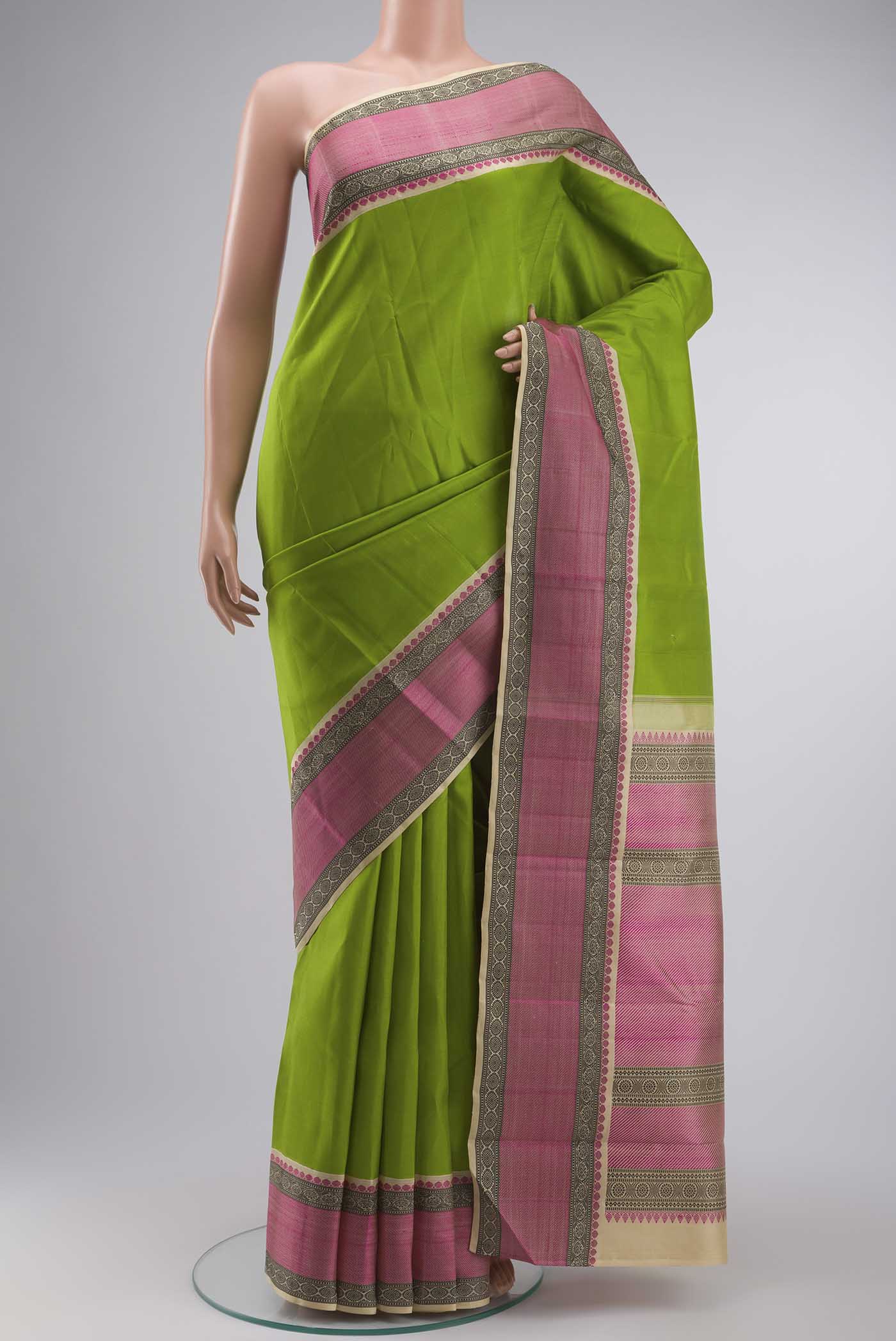 Green Kanchipuram Silk Saree with Plain Body and Thread Border displayed on a mannequin