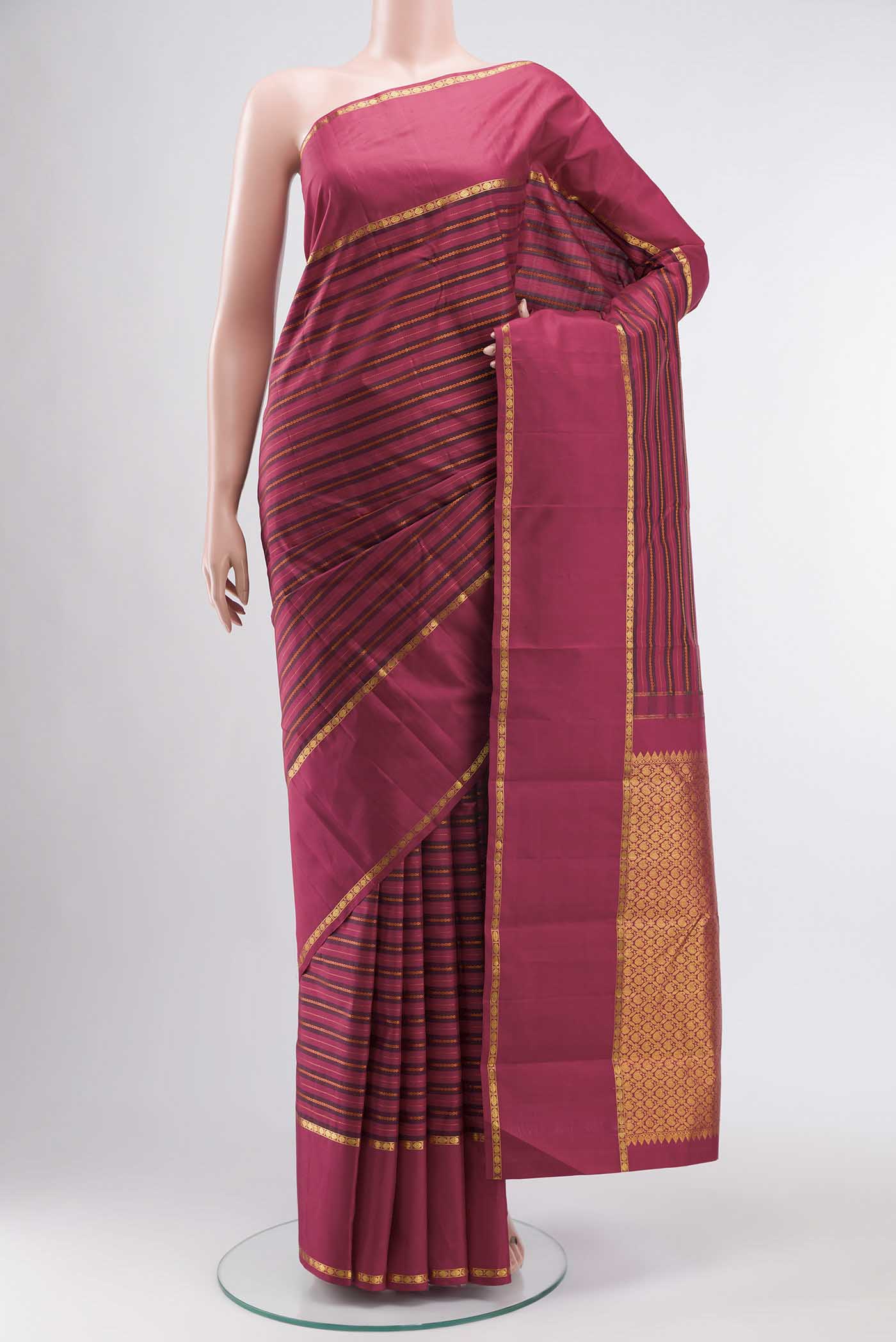 Maroon Kanchipuram Silk Saree with Stripes on the body and Zari Border displayed on a mannequin