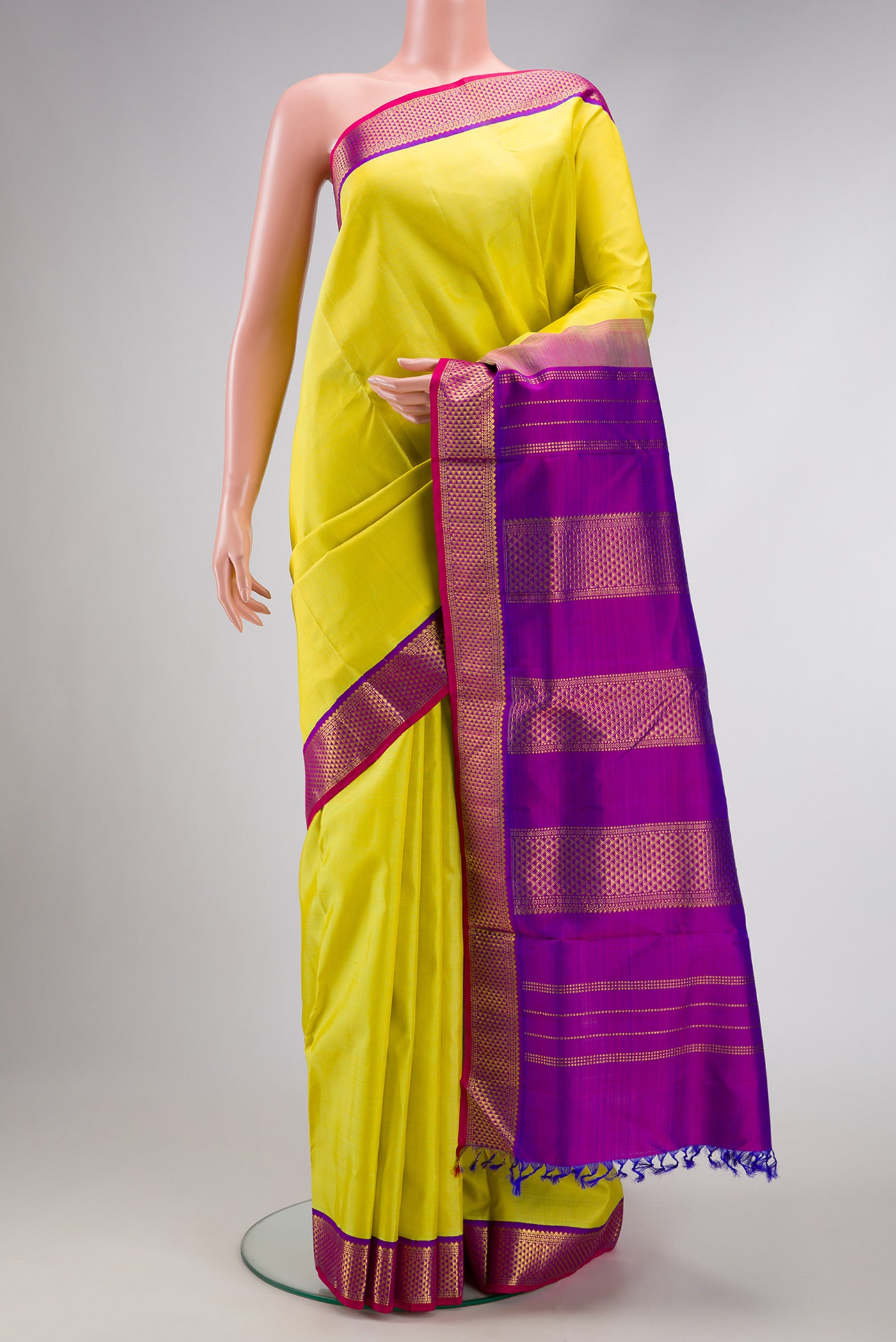 Pure Silk Pure Zari Parrot Green Dual Tone Kanchipuram Nine Yards Saree with Plain Body and Ganga Jamuna Border.  displayed on a mannequin