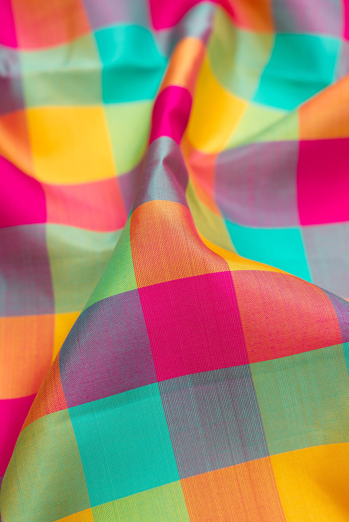 Close up of Pure Silk Pure Zari Sea Green , Yellow and Dark PInk Color Kanchipuram Nine Yards Saree with Checked design on the body and Zari Border.  displaying folds