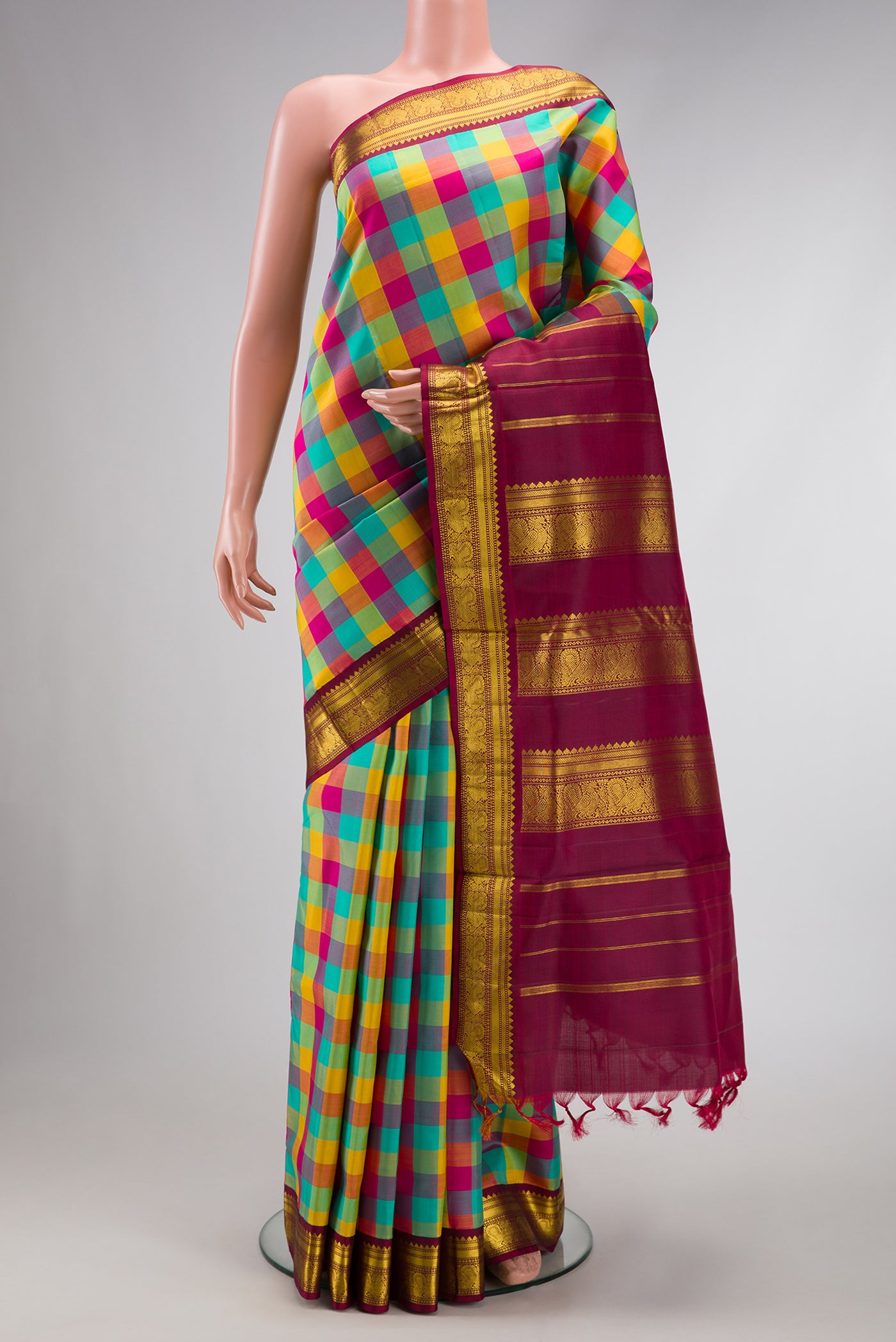 Pure Silk Pure Zari Sea Green , Yellow and Dark PInk Color Kanchipuram Nine Yards Saree with Checked design on the body and Zari Border.  displayed on a mannequin