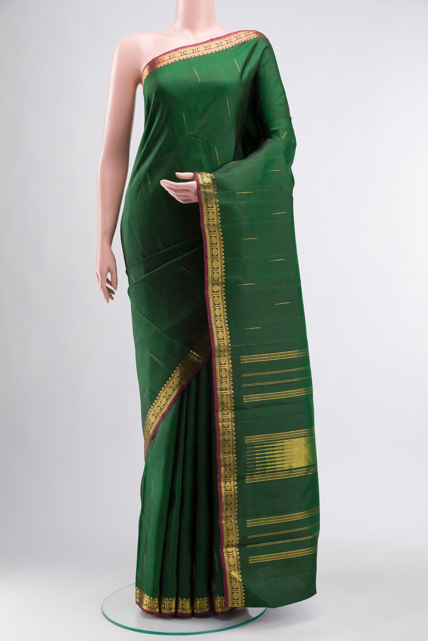 Green Kanchipuram Silk Saree with Zari Butta on the body and Zari Border displayed on a mannequin