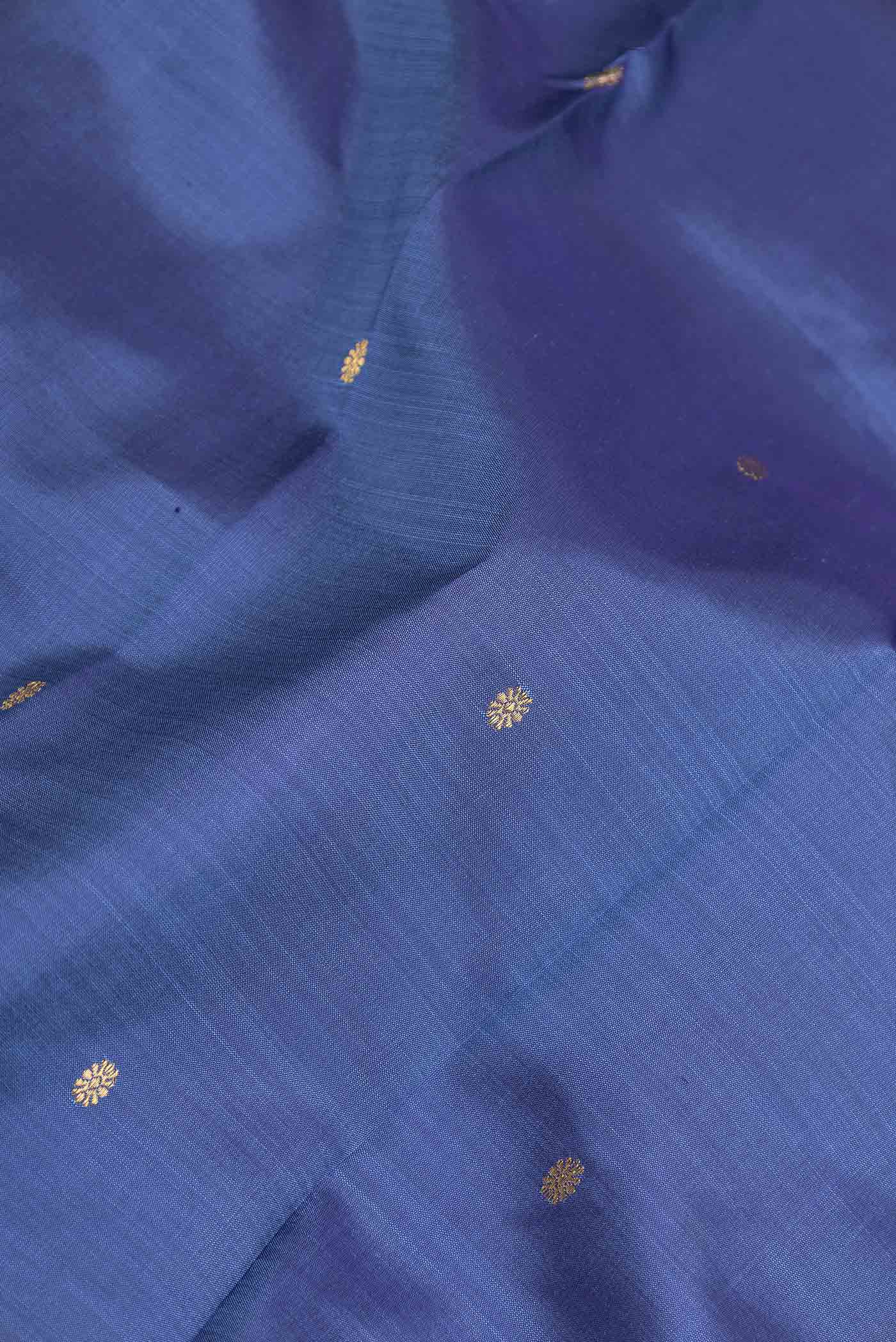 Close up of Blue Dual Tone Kanchipuram Saree with Zari Butta on the body and Zari Border displaying folds