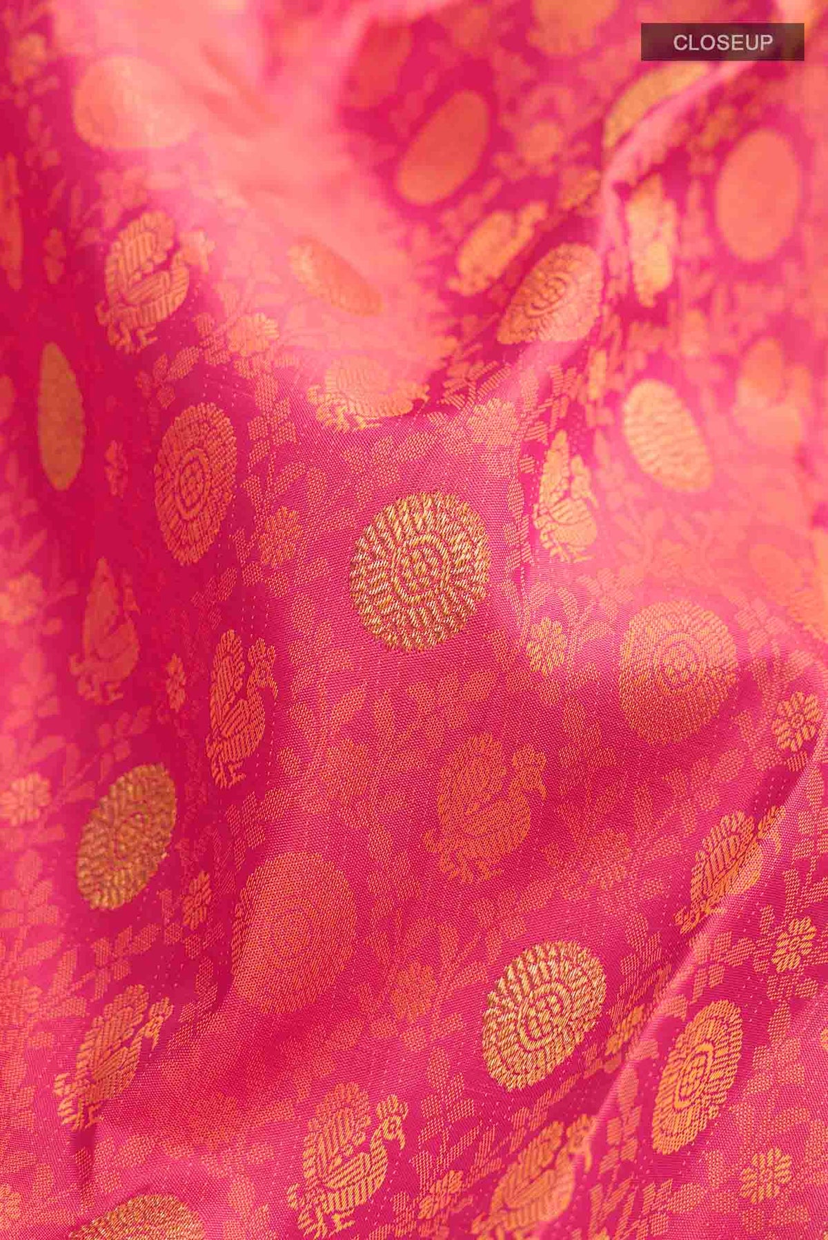 Close up of Pink Kanchipuram Silk Saree with Jacquard With Zari Butta on the body and Zari Border displaying folds