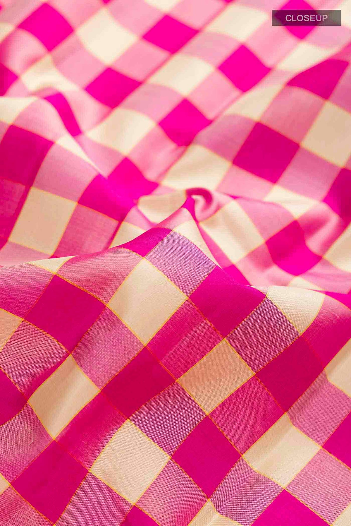Close up of Multi Color Kanchipuram Silk Saree with Checked design on the body and Thread Border displaying folds