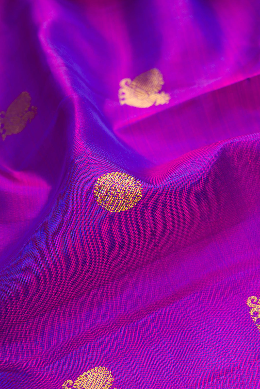 Close up of Purple Dual Tone Kanchipuram Silk Saree with Zari Butta on the body and Zari Border.  displaying folds