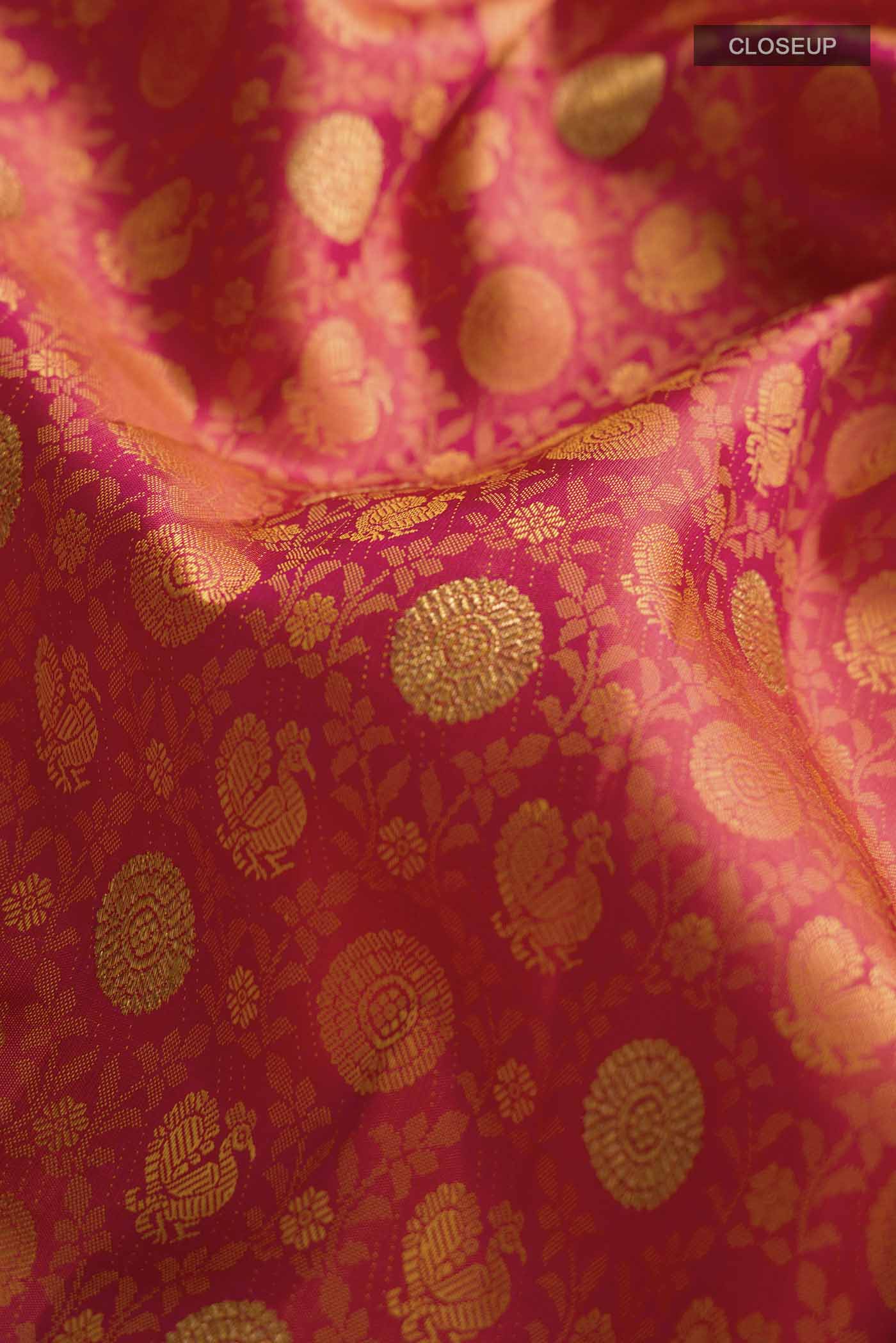 Close up of Pink Kanchipuram Silk Saree with Jacquard With Zari Butta on the body and Zari Border displaying folds
